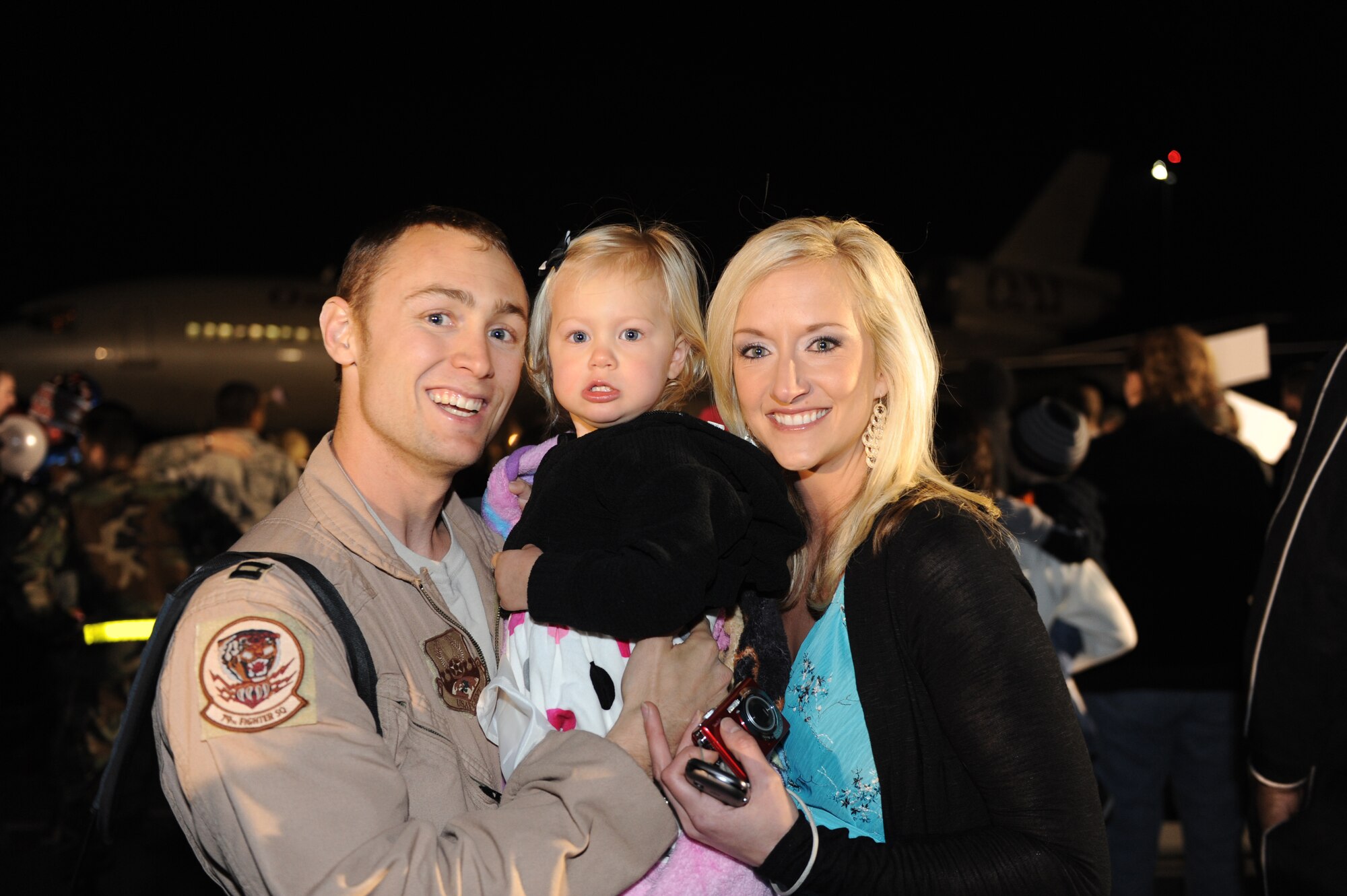 SHAW AIR FORCE BASE, S.C. -- Captain Corey Florendo reunites with his wife, Liz, and daughter, Maya. Hundreds of Airmen assigned to the 20th Fighter Wing returned this week after a four-month deployment in support of NATO efforts in Afghanistan.  (U.S. Air Force Photo/Tech. Sgt. Louis Rivers)