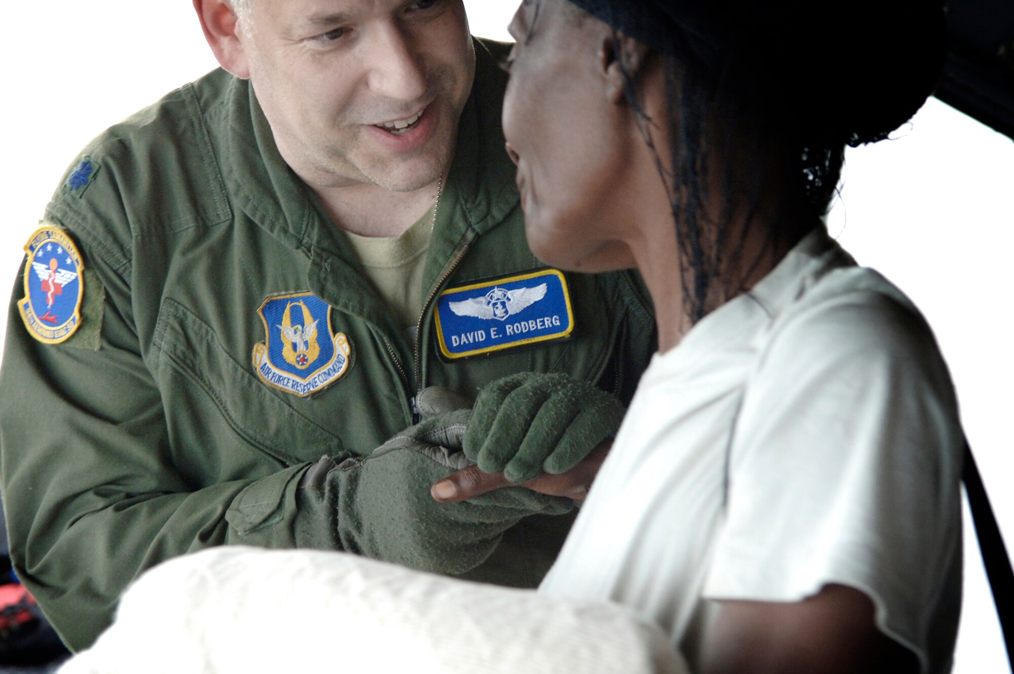 Lt. Col. David Rodberg bids farewell to one of the passengers on an aeromedical evacuation flight out of Haiti, Jan. 22 and 23, 2010. In all, 18 urgent care patients, four critical-care patients and 26 attending family members were escorted by Colonel Rodberg's team, based at Dobbins Air Reserve Base, Ga. Colonel Rodberg is the medical crew director of the 94th Aeromedical Evacuation Squadron. (U.S. Air Force photo/2nd Lt. Nicholas Mercurio)