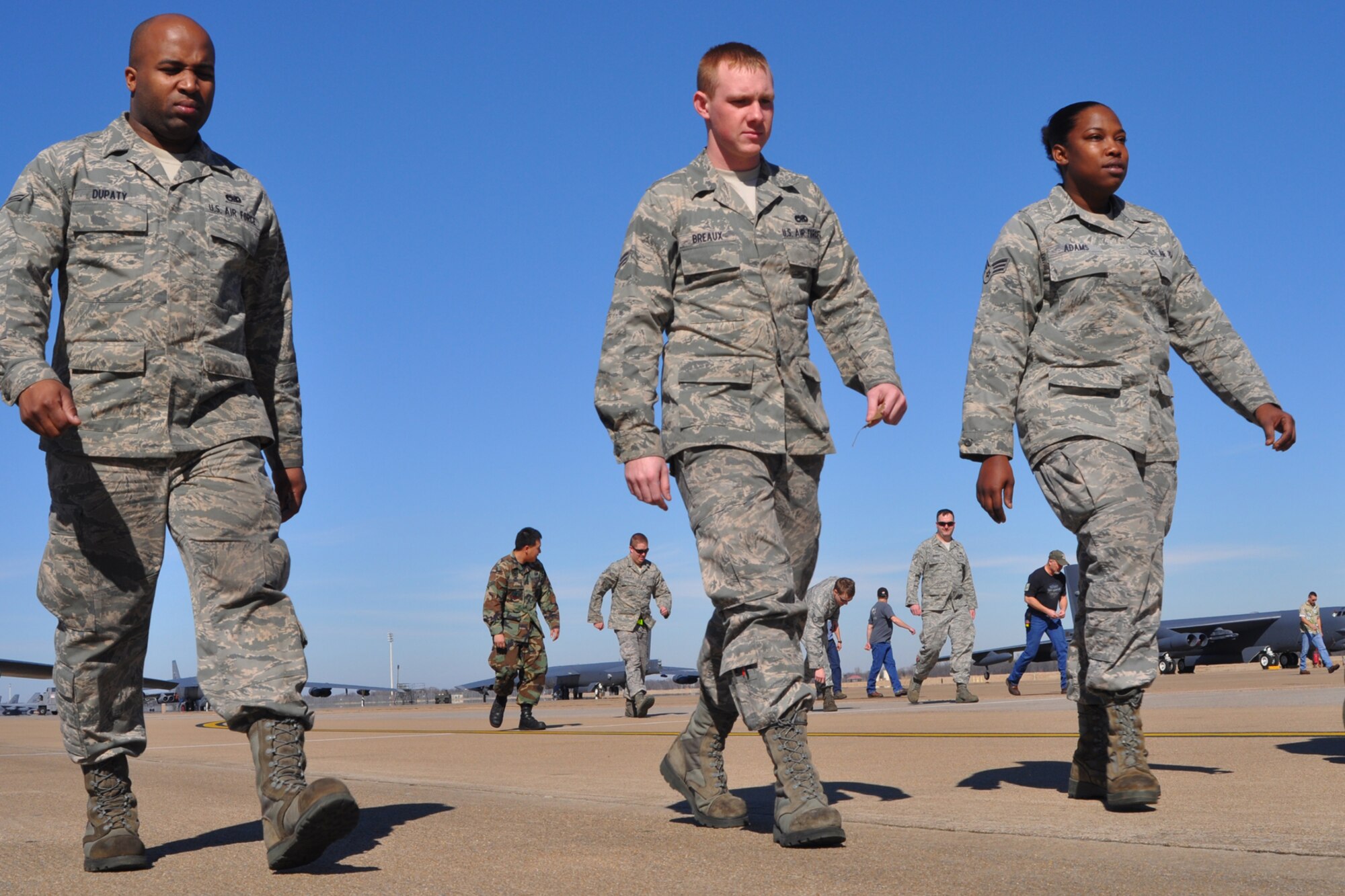 Airman 1st Class Curtis Dupaty, a hydraulic systems mechanic for the 917th Aircraft Maintenance Squadron on Barksdale Air Force Base, La., walks alongside Airman 1st Class Christopher Breaux and Senior Airman Ashton Adams, also hydraulic systems mechanics for the 917th AMXS, during a foreign object damage (FOD) walk on Barksdale’s flight line Jan. 22, 2010. The 917th AMXS walk the flight line every Friday, collecting any type of FOD, and removing it in order to minimize the chances of damage to aircraft like the B-52 Stratofortresses the unit is responsible for maintaining and repairing on base.   (U.S. Air Force Photo/Senior Airman Crystal Marie Jordan)