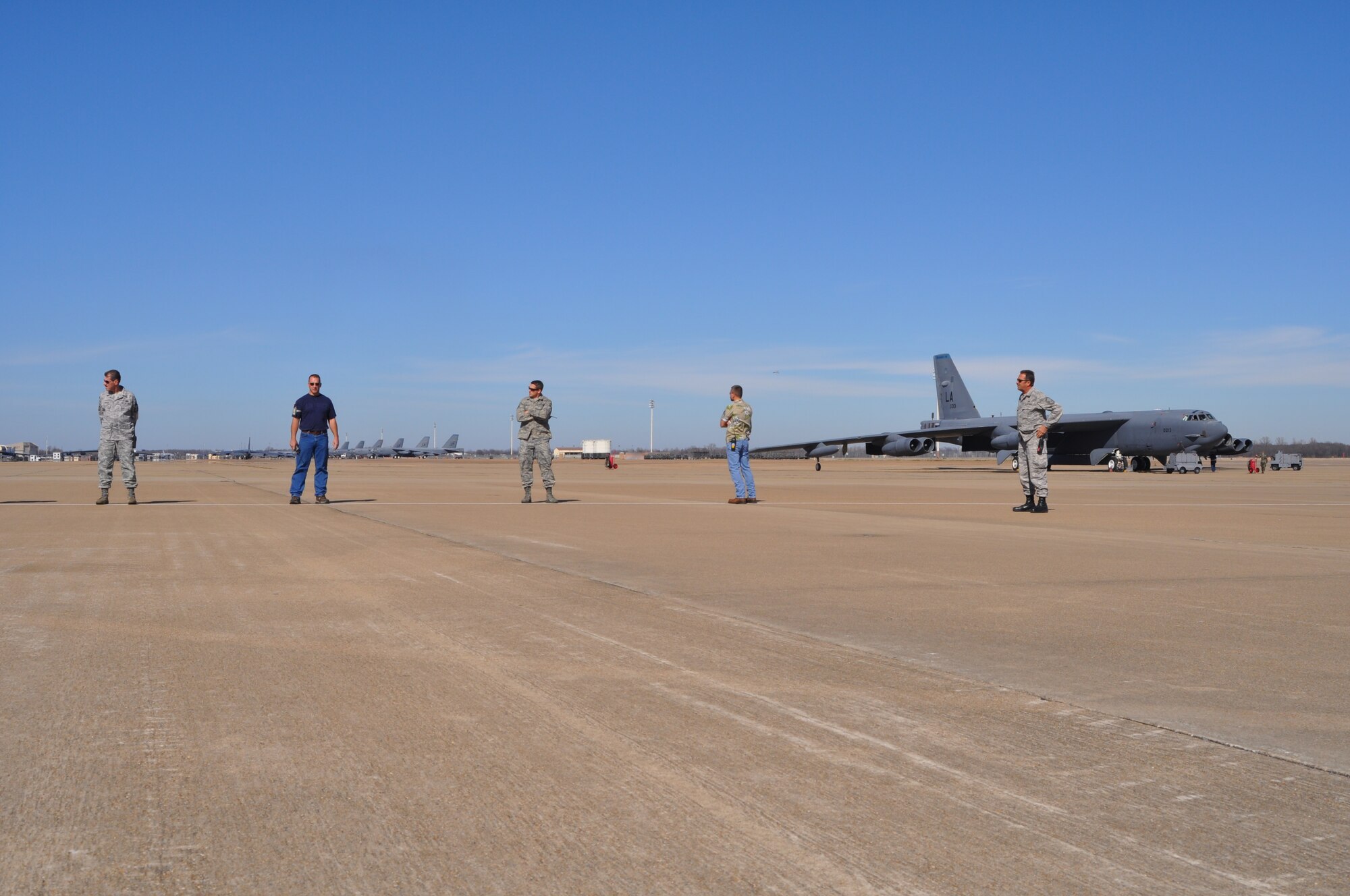 Senior Master Sgt. Thomas Hoffman, a 917th Aircraft Maintenance Squadron superintendent at Barksdale Air Force Base, La., waits for personnel to line up while he supervises a foreign object damage (FOD) walk on Barksdale Jan. 22, 2010. The 917th AMXS conducts a FOD walk every Friday in order to minimize the chances of damage to aircraft. FOD could be any foreign object with the ability to cause damage to both aircraft and personnel on the flight line. (U.S. Air Force Photo/Senior Airman Crystal Marie Jordan)
