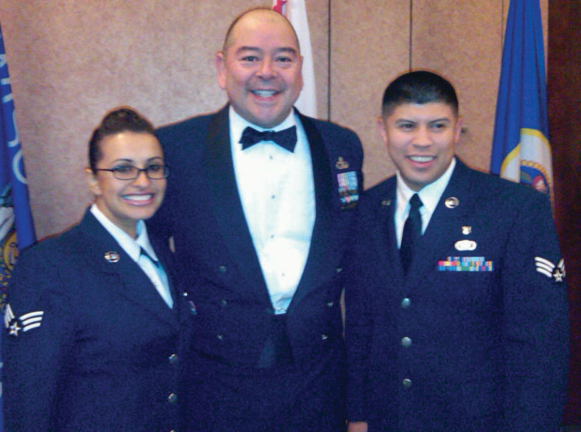 Chief Master Sgt. Agustin Huerta (center) stands with Senior Airman Ana Partida (left) and Senior Airman Juan Morales (right) after Airman Leadership School graduation Dec. 3, 2009, at Travis AFB.  Airman Partida is with the 452nd Mission Support Squadron and Airman Morales is from the 752nd Aerospace Medicine Squadron.
