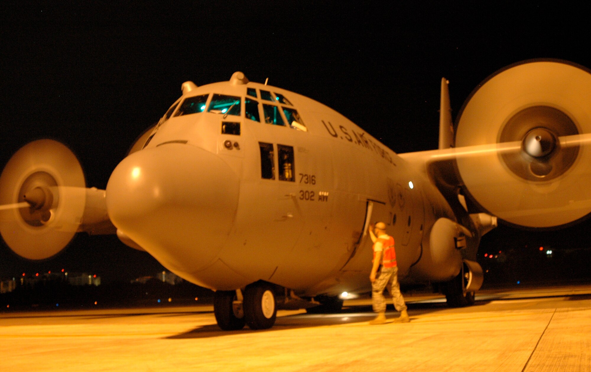 Tech. Sgt. Brad Dahl, a crew chief deployed from the Minnesota Air National Guard's 133rd Airlift Wing, closes the hatch on an Air Force Reserve C-130 Hercules Jan. 25 at Muniz Air Base, Puerto Rico. Moments later, the C-130 and its crew took off, performing their first mission in support of Haiti earthquake relief operations since deploying the Caribbean. Approximately 50 members of the 302nd AW deployed to Muniz Jan. 23 in support of Air Expeditionary Force Coronet Oak, operated by the 35th Expeditionary Airlift Squadron. The 133rd AW is based at St. Paul-Minneapolis, Minn. (U.S. Air Force photo/Staff Sgt. Stephen J. Collier)