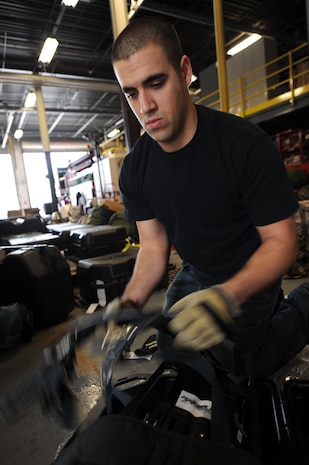 Senior Airman Josh McCue loads a self-contained breathing apparatus into a protective case to be loaded onto a pallet on Charleston AFB, Jan. 22. The SCBA provides oxygen to the firefighters when they are in an environment that they would be unable to breathe normally by themselves. Airman McCue is a firefighter with Pope AFB, N.C. (U.S. Air Force photo/Senior Airman Katie Gieratz)(RELEASED)