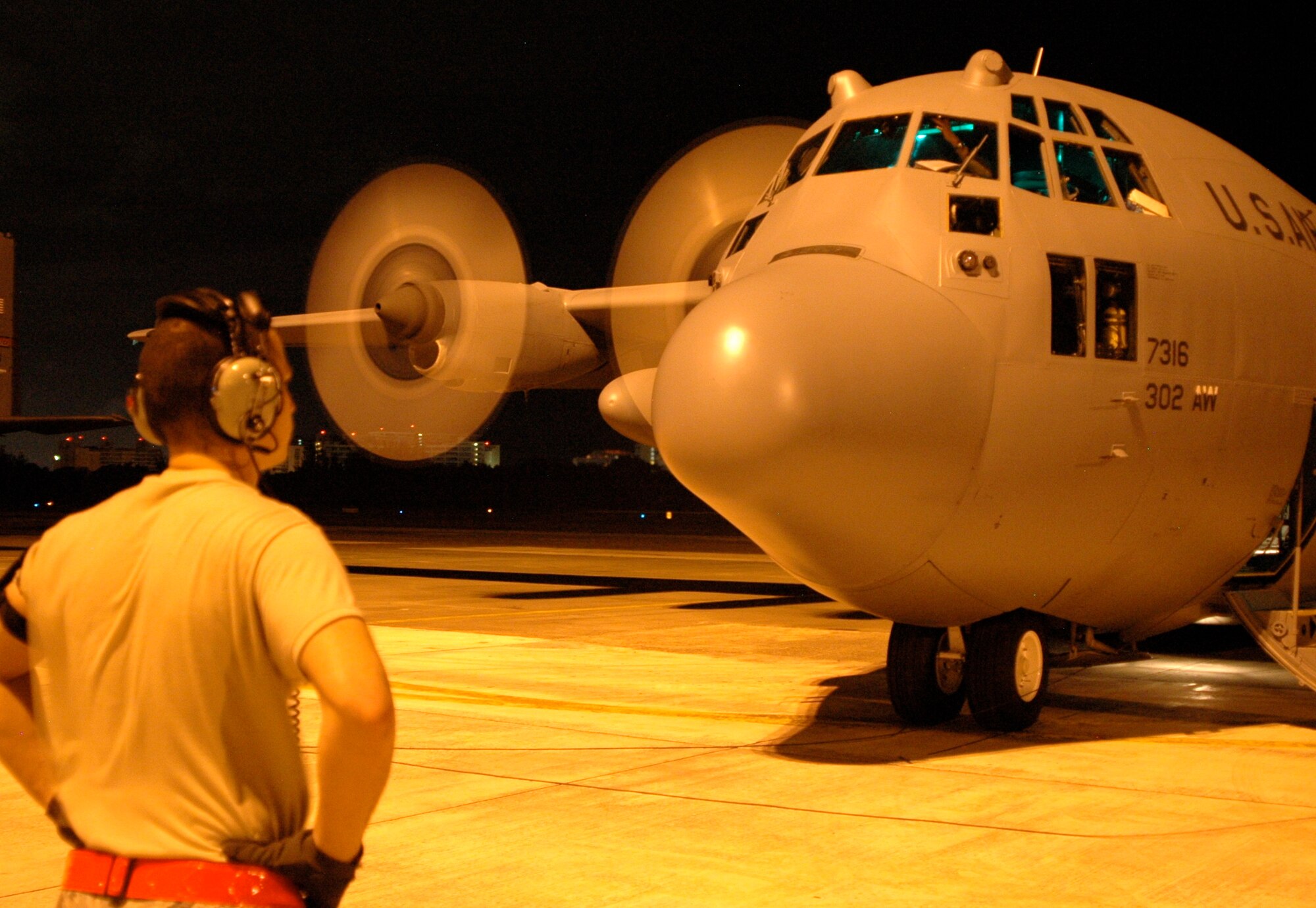 Staff Sgt. Daniel Osorio, an Active Duty C-130 Hercules crew chief deployed from the Air Force Reserve's 302nd Airlift Wing, looks over the aircraft before boarding it Jan. 25 at Muniz Air Base, Puerto Rico. Moments later, the C-130 and its crew took off, performing their first mission in support of Haiti earthquake relief operations since deploying the Caribbean. Approximately 50 members of the 302nd AW deployed to Muniz Jan. 23 in support of Air Expeditionary Force Coronet Oak, operated by the 35th Expeditionary Airlift Squadron. Sergeant Osorio is assigned to the 52nd Airlift Squadron, an Active Duty Air Force squadron associated with the AF Reserve's 302nd AW. (U.S. Air Force photo/Staff Sgt. Stephen J. Collier)