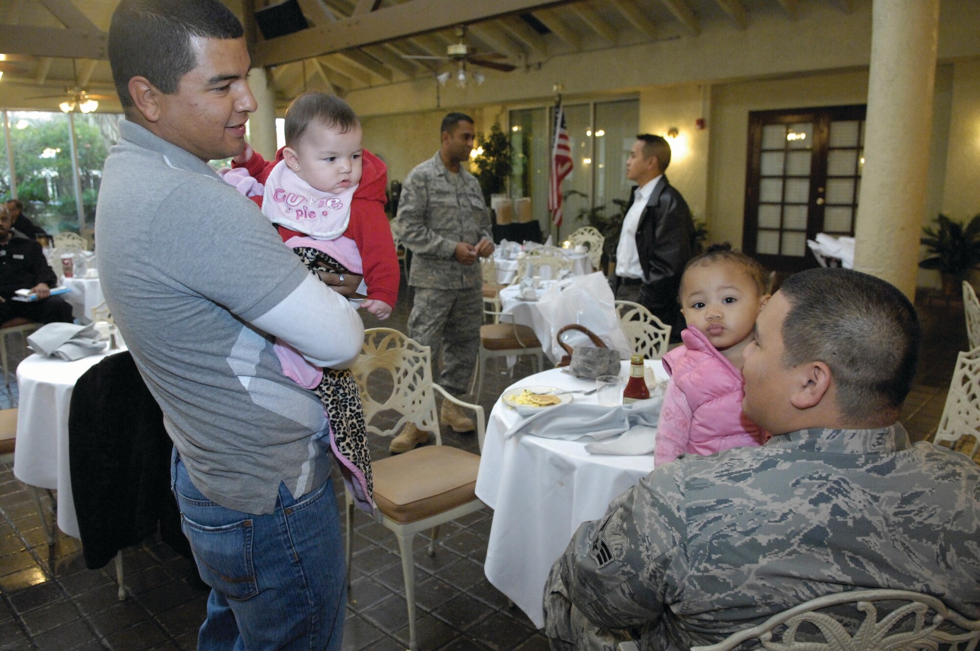 Two of the Yellow Ribbon Reintegration Program participants and their children talk during breakfast at the Hap Arnold Club Dec. 11.  The program was targeted toward service members who have recently returned from deployment and their family members.  After breakfast, the adults attended seminars while the children retreated to a play room staffed with child care professionals.  The program was the third Yellow Ribbon event hosted by March ARB and 105 people were in attendance.