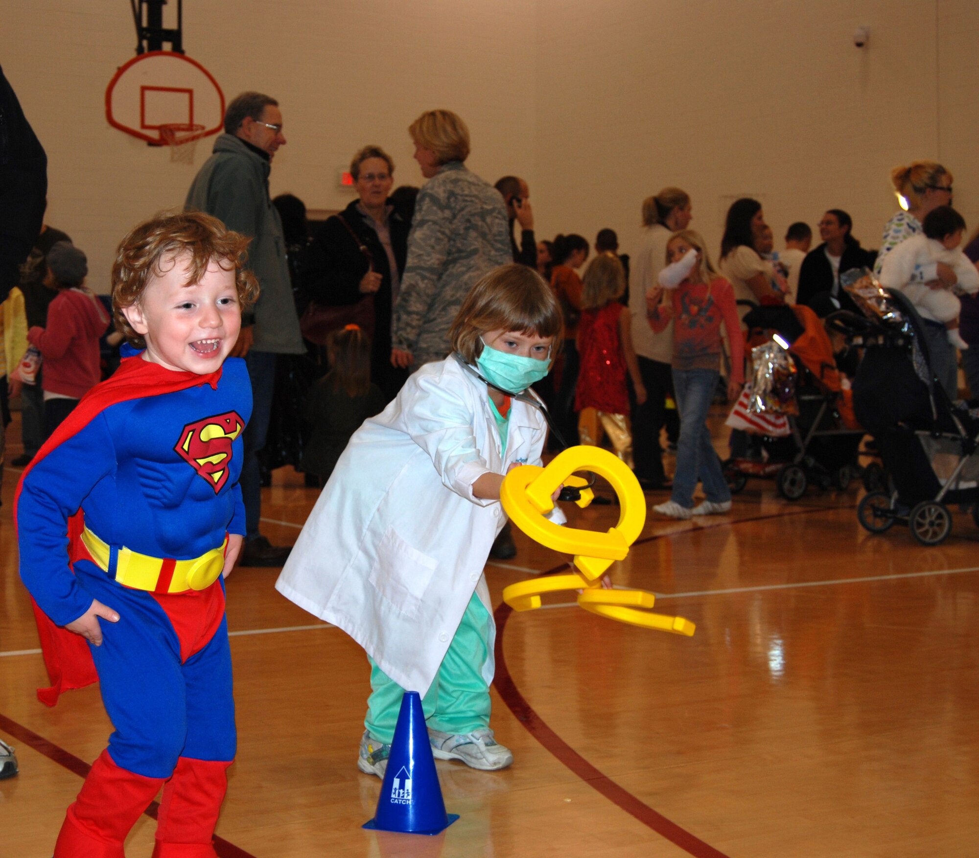 (Left to right) Alexander Crampton, 3, and Lindsey Davison, 6, play the games at the Harvest Festival, Oct. 30 2009, which was held to kick off the Year of the Air Force Family. This campaign was named by the Secretary and Chief of Staff of the Air Force to emphasize the importance of family. (U.S. Air Force photo/courtesy photo)