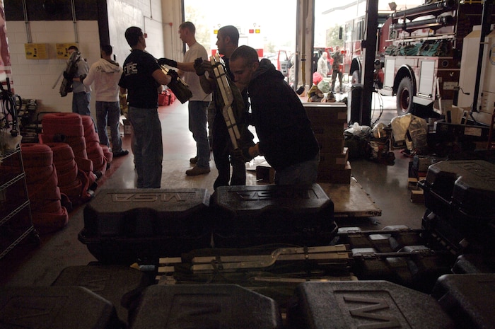 Airmen from different bases across the Air Force form an assembly line at Charleston AFB to stack cots on a pallet bound for Haiti Jan. 22. The pallet included oxygen tanks and cots for the Airmen to enable them to support the relief efforts in Haiti. Their efforts include numerous tasks from rescue missions to working with the aircraft. The Airmen are all fire fighters assigned to various civil engineer squadrons. (U.S. Air Force photo/Airman 1st Class Lauren Main)