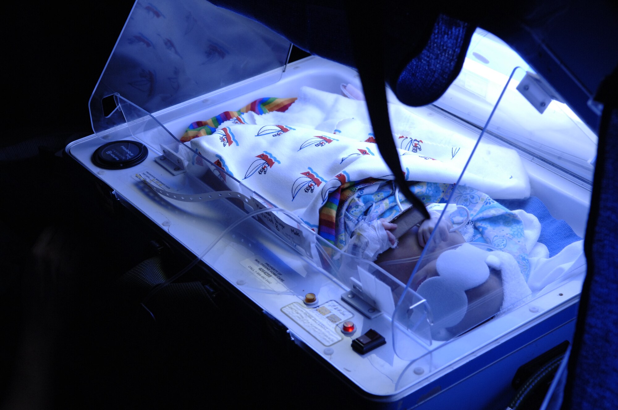 An 8-day-old Haitian child born 10-weeks premature rests in a mobile incubator onboard an Air Force aeromedical evacuation flight out of Haiti Jan. 22.  Less than six hours from the time the aircraft was loaded, its critical-care patients were on ambulances bound for Miami-area hospitals.  (U.S. Air Force photo by 2nd Lt. Nicholas Mercurio/Released)