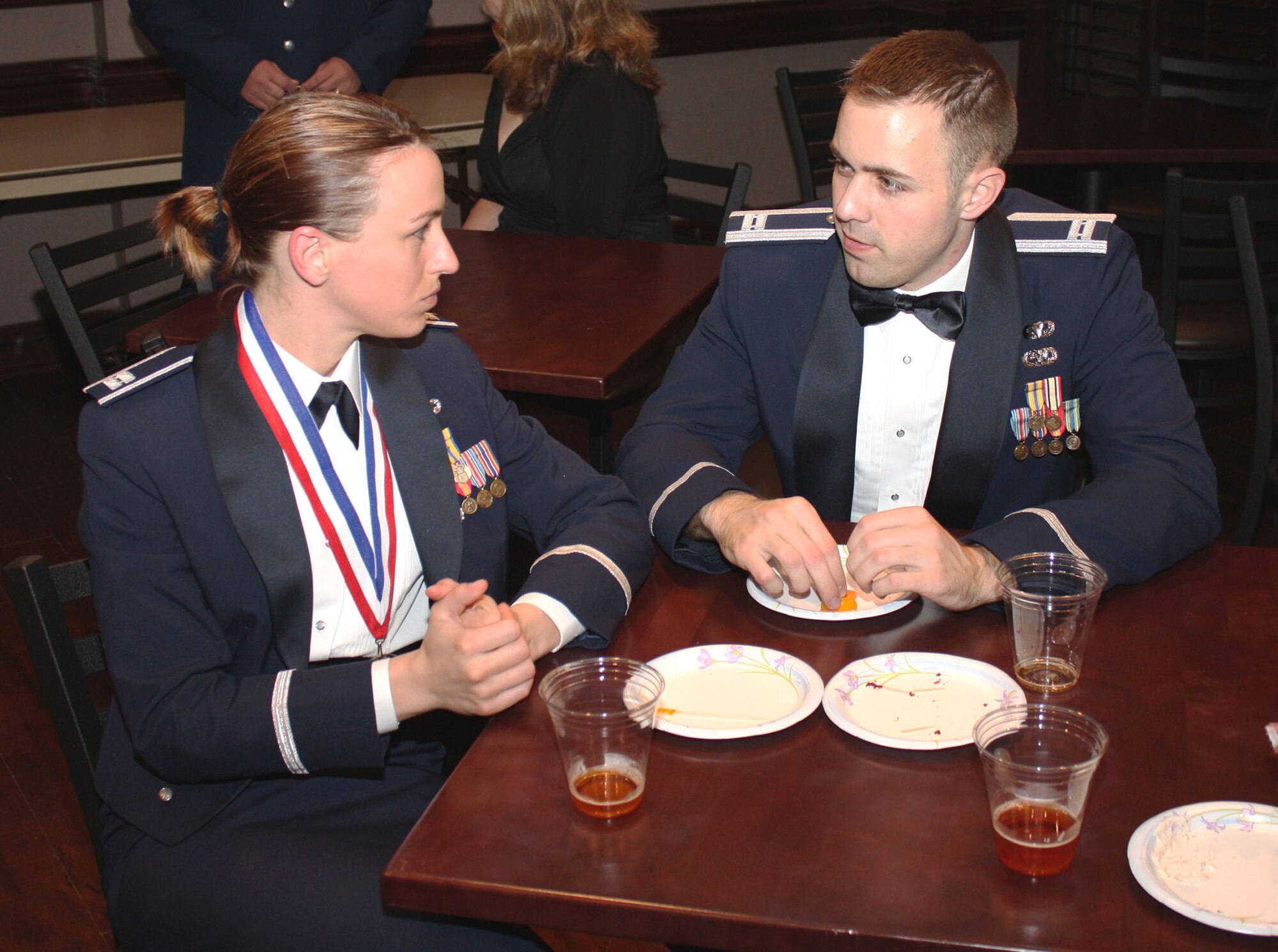 TRAVIS AIR FORCE BASE, Calif. Capt. Lindsey M. Ballinger, a 749th Aircraft Maintenance Squadron member, converses with Capt. Justin M. Hickey, a 660th Aircraft Maintenance Squadron member, during the 349th Annual Awards Banquet at the Delta Breeze Club, Jan 23. Capt. Ballinger was a nominee for the 349th Air Mobility Wing Company Grade Officer of the Year category at the 349th AMW Annual Awards Banquet. (U.S. Air Force photo/Master Sgt. Robert Wade)