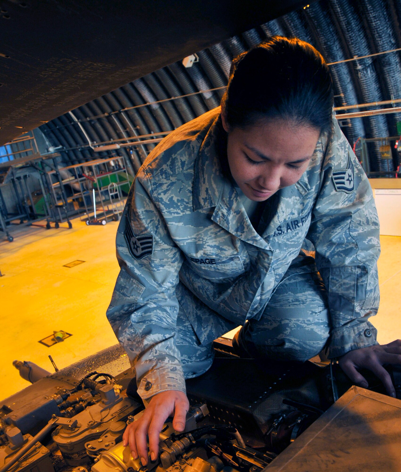 SSgt Jo LePage, 748th Aircraft Maintenance Squadron, 56th Helicopter Maintenance Unit crew chief works on a piece of equipment inside one of the hangars on the flight line.  Sergeant LePage was nominated for this crew chief spotlight by her chain of command because of the excellent work she does providing maintenance support.