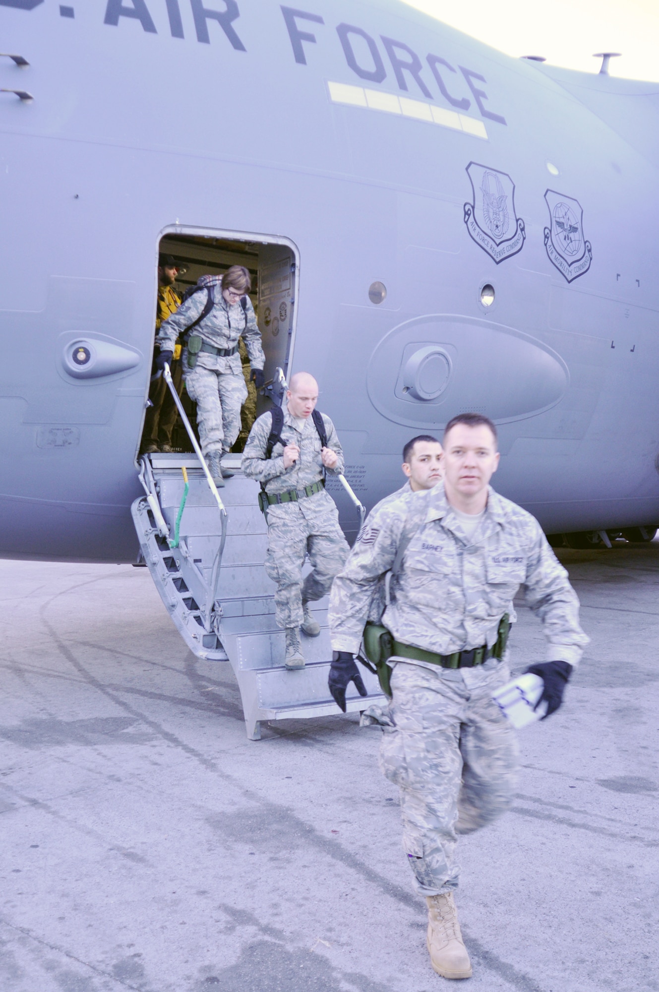 Airmen step off a C-17 Globemaster III Jan. 22, 2010, at Port-au-Prince airport, Haiti. The group will be deployed there for at least 45 days. They will load and unload cargo and passengers from aircraft going in and out of Port-au-Prince as part of the massive multinational relief effort underway there. (U.S. Air Force photo/Kari Tilton)