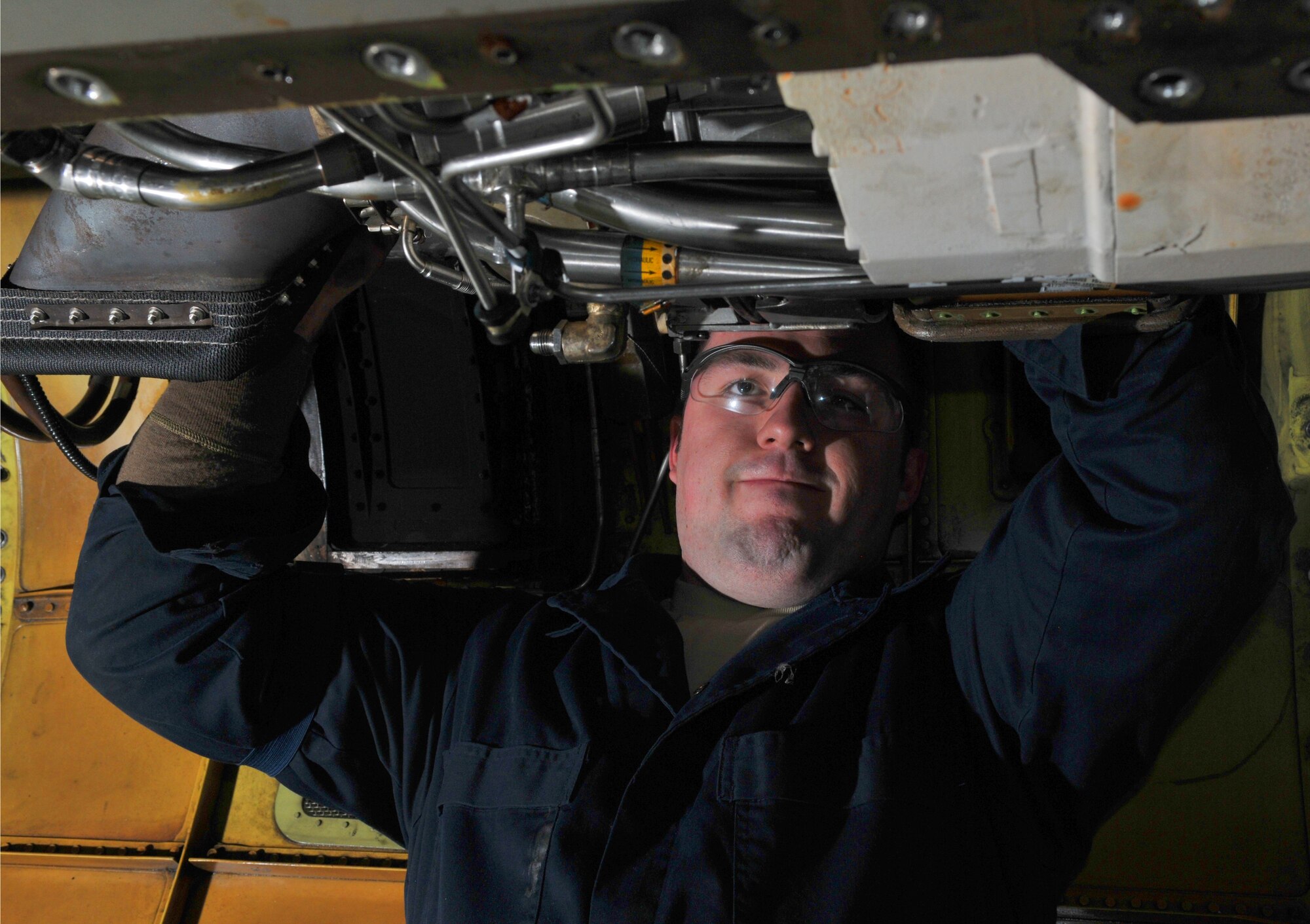 SPANGDAHLEM AIR BASE, Germany -- Senior Airman Brandon Wood, 52nd Equipment Maintenance Squadron F-16 Fighting Falcon crew chief, installs jet fuel starter on an F-16 in Hangar 2 Jan. 21.  The jet fuel starter was removed to facilitate additional maintenance. (U.S. Air Force photo/Airman 1st Class Nick Wilson)