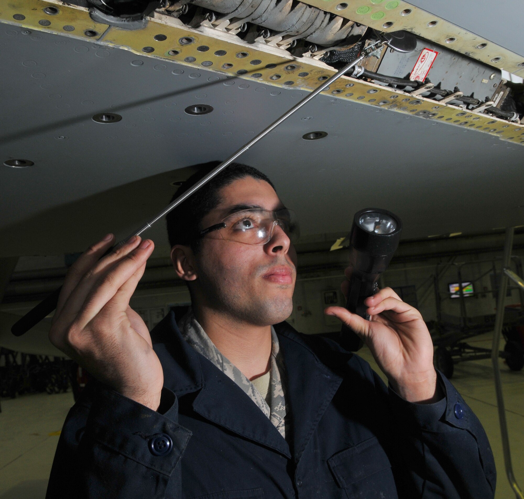 SPANGDAHLEM AIR BASE, Germany -- Airman 1st Class Ryan Mercado, 52nd Equipment Maintenance Squadron F-16 Fighting Falcon crew chief, inspects the leading edge flap as part of an F-16's 400-hour phase inspection in Hangar 2 Jan. 21. The phase inspection is essential to keep the aircraft mission capable. (U.S. Air Force photo/Airman 1st Class Nick Wilson)