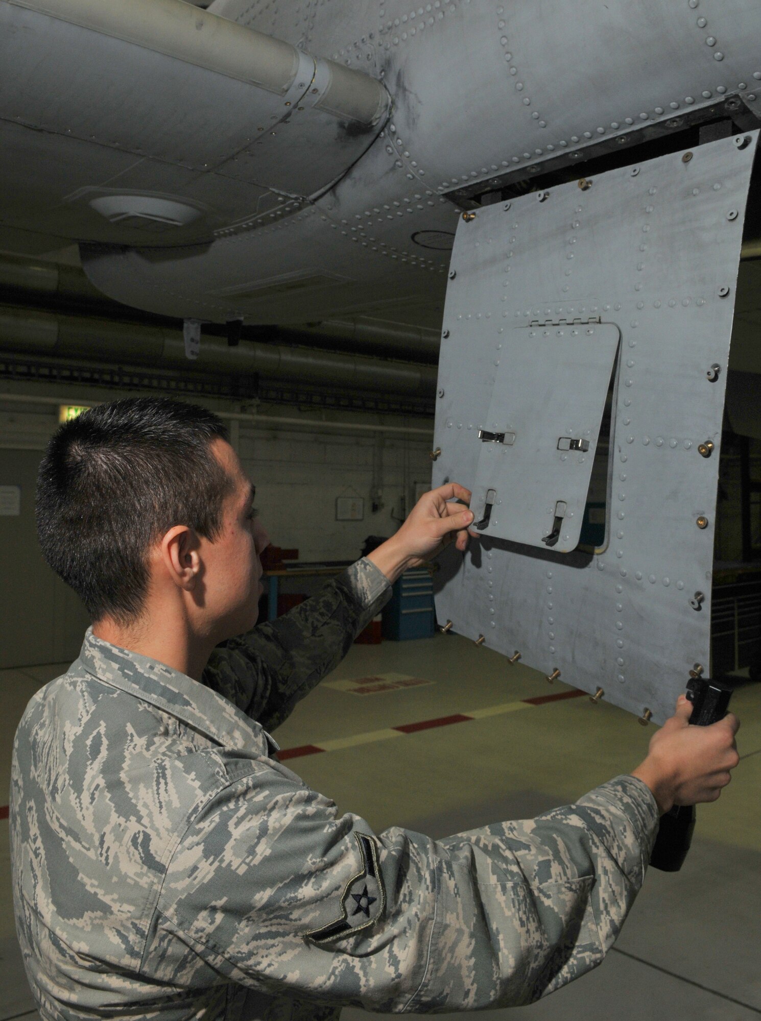 SPANGDAHLEM AIR BASE, Germany -- Airman Richie Washoe, 52nd Equipment Maintenance Squadron, inspects an A-10 Thunderbolt II's panels for cracks Jan. 21 in Hangar 2 to ensure the fasteners and serviceability of the panels are safe for flight. This was completed as part of the A-10's phase inspection checklist, which is separated into two phases. Within each phase, about 675 maintenance manuals called "work cards" are used to inspect different areas of the aircraft. (U.S. Air Force photo/Airman 1st Class Nick Wilson)