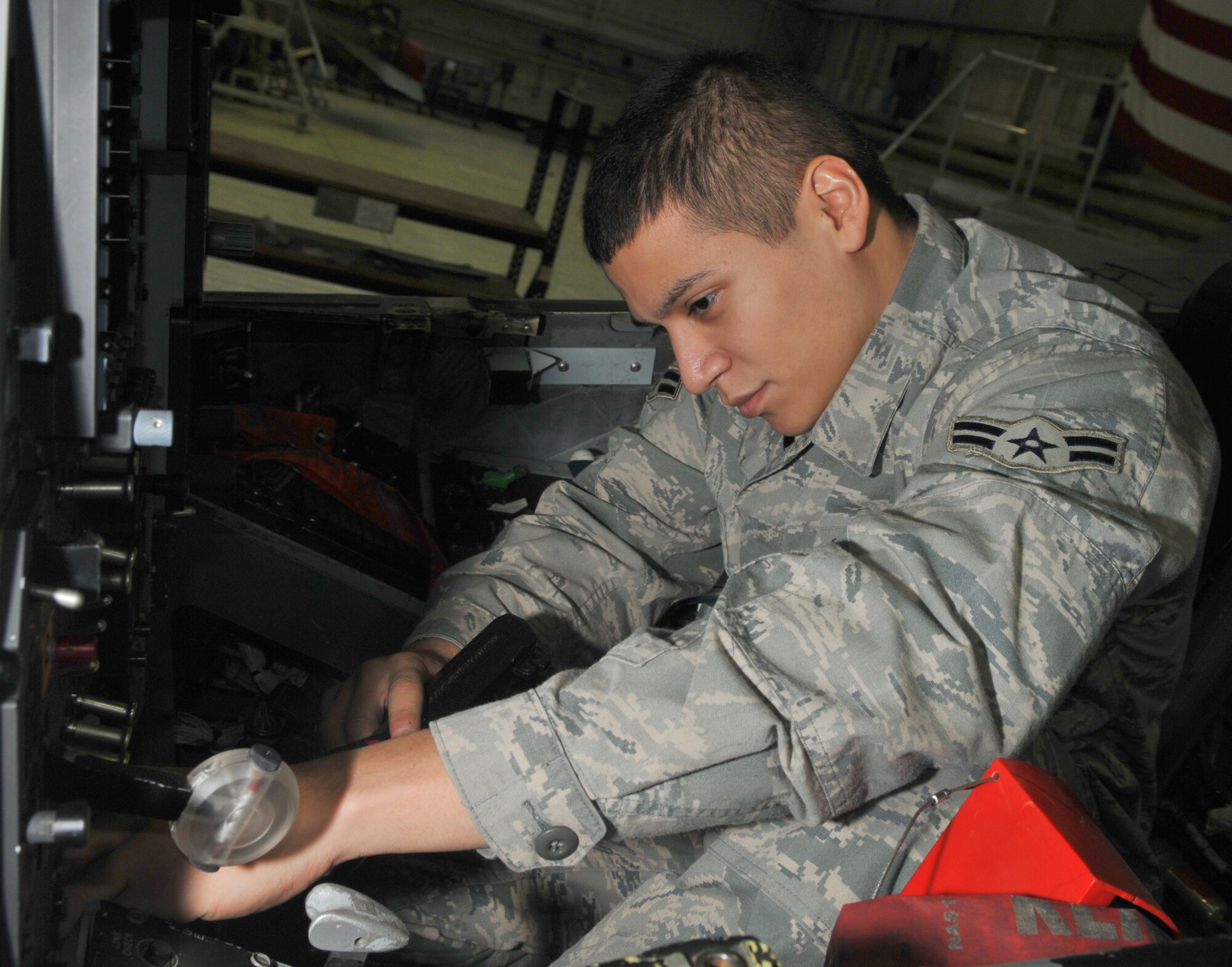 SPANGDAHLEM AIR BASE, Germany -- Airman 1st Class Randy Zuniga, 52nd Equipment Maintenance Squadron, inspects an A-10 Thunderbolt II's ejection seat Jan. 21 in Hangar 2. This was completed as part of the A-10's phase inspection checklist, which is separated into two phases. Within each phase, about 675 maintenance manuals called "work cards" are used to inspect different areas of the aircraft. (U.S. Air Force photo/Airman 1st Class Nick Wilson)