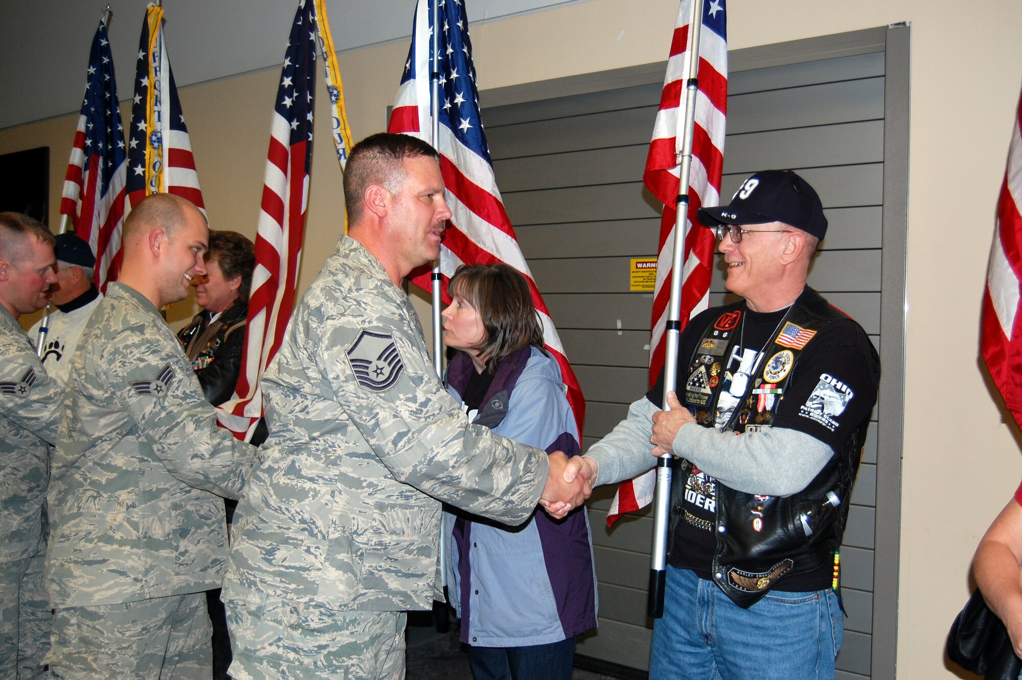 WRIGHT-PATTERSON AIR FORCE BASE, Ohio - Members of the Ohio Patriot Guard Riders welcome home Senior Airman Tim Sexton and Master Sgt. Greg Myers, both from the 445th Security Forces Squadron, at the Dayton International Airport Jan. 17 as the Airmen return from a 197-day deployment in Iraq. While deployed the Airmen performed various security forces functions to include base security, vehicle searches, gate security, patrol, and tower duties. (U.S. Air Force photo/Maj. Cynthia Harris)
