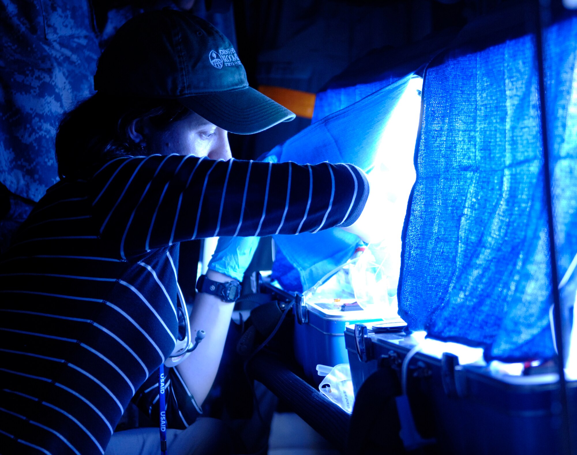 Dr. Maggie Brewinski, a pediatrician with the U.S. Agency for International Development, checks on two 8-day-old twins who were born 10-weeks premature onboard an Air Force aeromedical evacuation flight out of Haiti, Jan. 22.  The infants were treated with IV-fluids and antibiotics and were warmed by two mobile incubators during flight.  (U.S. Air Force photo by 2nd Lt. Nicholas Mercurio/Released)