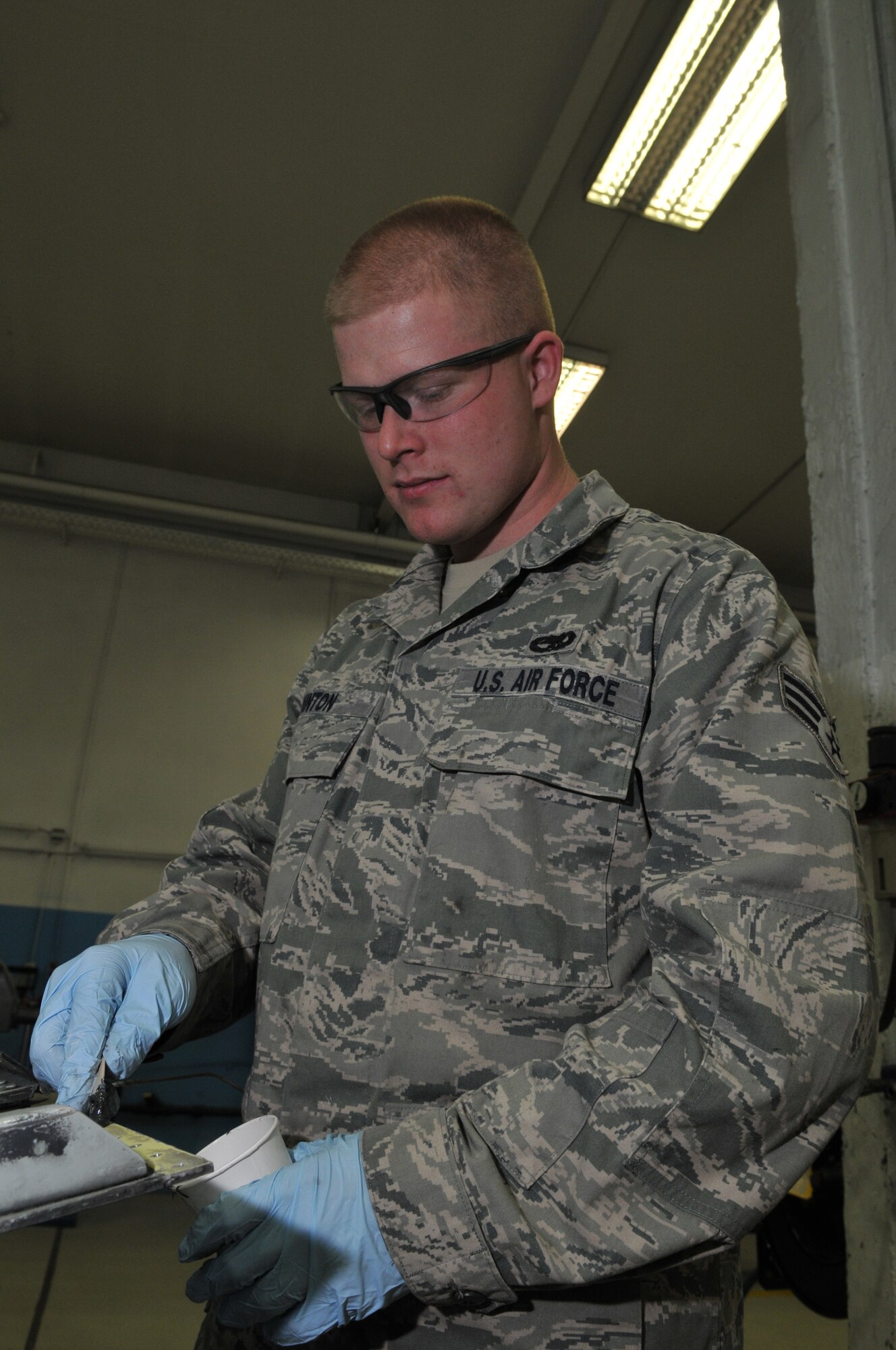 SPANGDAHLEM AIR BASE, Germany -- Senior Airman Ray Vinton, 52nd Equipment Maintenance Squadron, applies sealant compound to a gun access door for an A-10 Thunderbolt II Jan. 21 in the aircraft structural maintenance shop. The sealant compound keeps water from getting between the metal and corroding layers of an aircraft's structure. (U.S. Air Force photo/Airman 1st Class Nick Wilson)