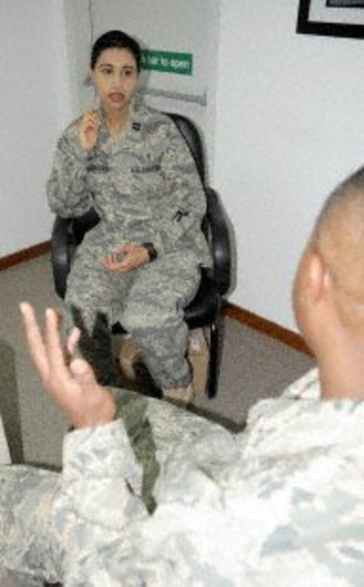 Capt. (Dr.) Kieran Dhillon-Davis, clinical psychologist and chief of mental health for the 380th Expeditionary Medical Group, talks with an Airman during operations at a non-disclosed location in Southwest Asia on Jan. 22. Dhillon-Davis earned her doctorate of psychology from Loma Linda University, Calif., in 2006 and has been in the Air Force for five years. She is deployed from the 82nd Medical Operations Squadron at Sheppard Air Force Base, Texas, and her hometown is Redlands, Calif. (U.S. Air Force photo courtesy)