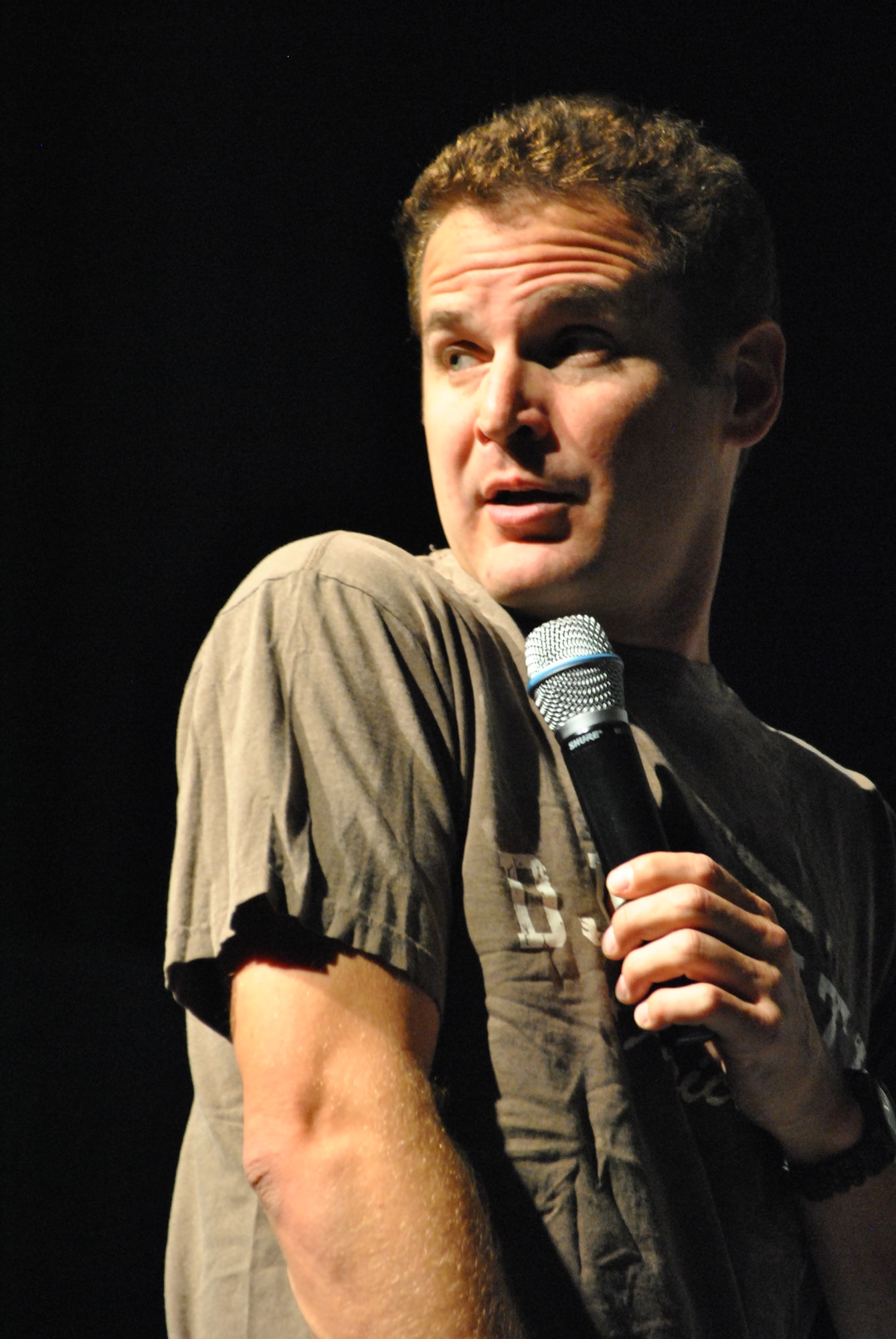 Johnny Cardinale, Comedy Corps member, performs as part of the "Disarmed and Dangerous" comedy show at the Coalition Compound Theatre at a non-disclosed Southwest Asia location, Jan. 23, 2010. The comedy troupe, also including Matt Baetz and Lauren Ashley Bishop, is scheduled to appear at various locations throughout the AOR. (U.S. Air Force photo by Senior Master Sgt. David Byron) [RELEASED]