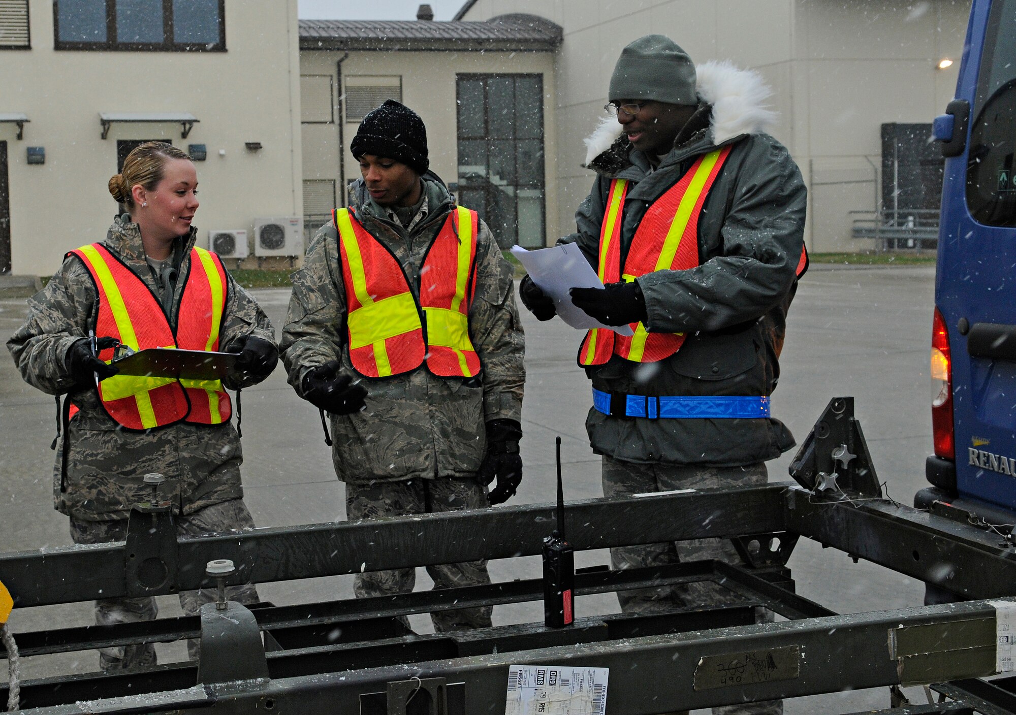 SPANGDAHLEM AIR BASE, Germany – Airman 1st Class Janine Vesey, Airman 1st Class Christopher Wood, and Senior Airman Wesley Kizer (left to right), all from the 52nd Logistics Readiness Squadron, review a piece of equipment’s paperwork before processing it for a simulated deployment during Operation Saber Crown 10-3 here Jan. 21. Members of the cargo deployment function ensure equipment meets all requirements, including proper paperwork, measurements and airworthiness, before it can be deployed. (U.S. Air Force photo/Senior Airman Benjamin Wilson)