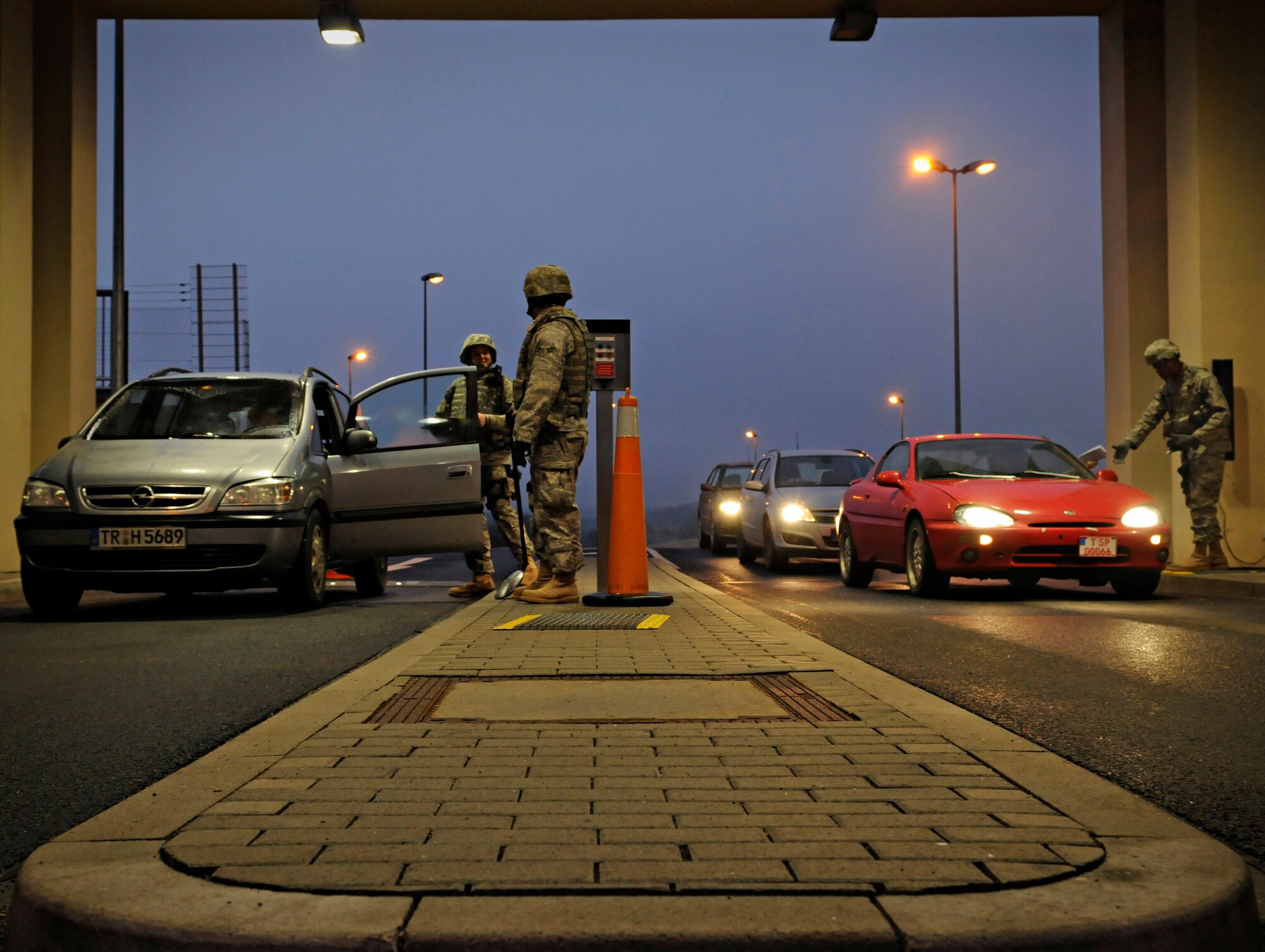SPANGDAHLEM AIR BASE, Germany – Members of the 52nd Security Forces Squadron check ID cards and inspect the vehicles of people entering Spangdahlem Air Base during Operation Saber Crown 10-03 Jan. 20. Members of the 52nd Fighter Wing participated in an exercise to prepare for an upcoming NATO evaluation. (U.S. Air Force photo/Senior Airman Benjamin Wilson)
