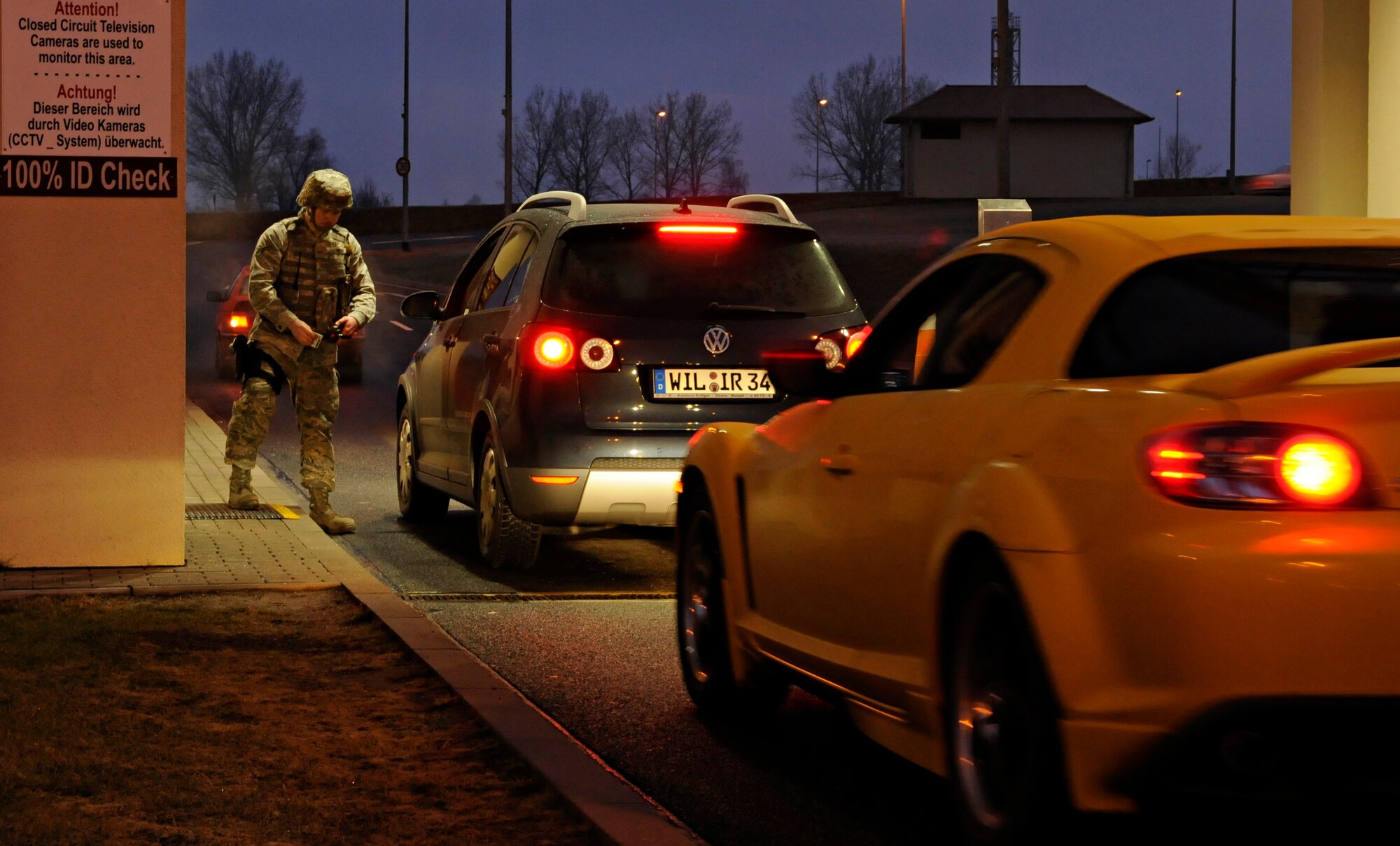 SPANGDAHLEM AIR BASE, Germany – Airman 1st Class Scott Johnson, 52nd Security Forces Squadron, checks the ID cards of people entering Spangdahlem Air Base during Operation Saber Crown 10-03 Jan. 20. The purpose of the exercise was to evaluate the preparedness of base members to rapidly deploy forces to a specific location. (U.S. Air Force photo/Senior Airman Benjamin Wilson)