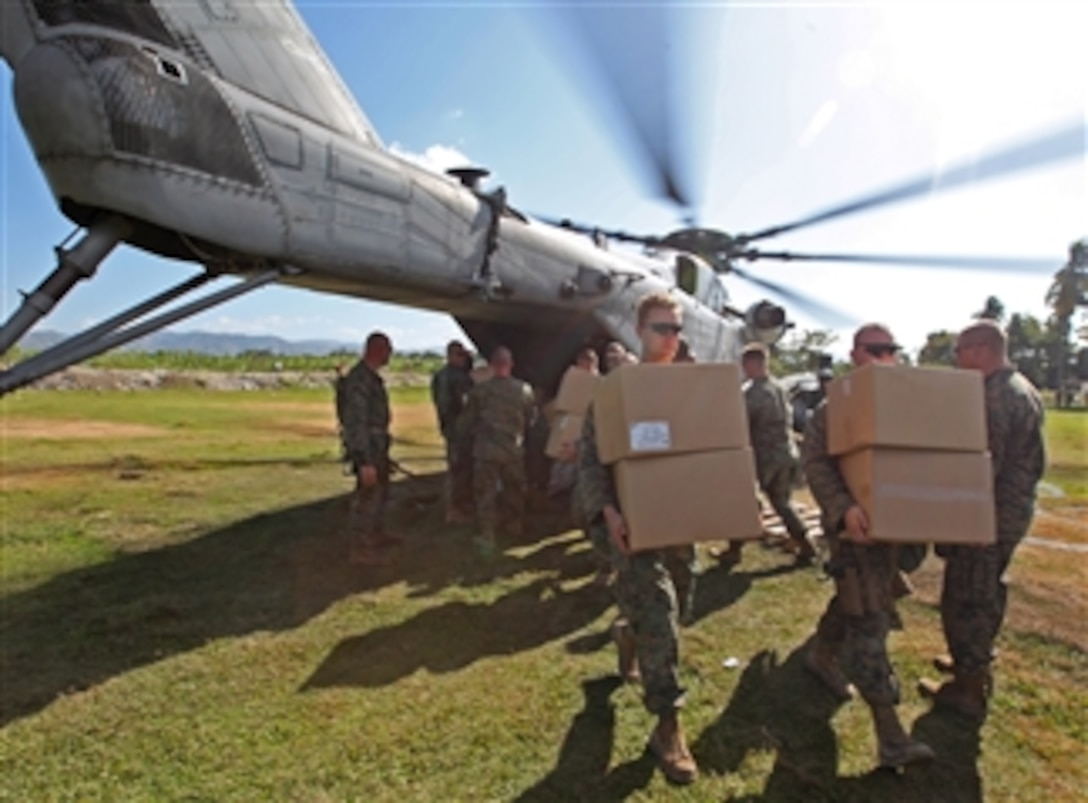 U.S. Marines with Battalion Landing Team, 3rd Battalion, 2nd Marine Regiment, 22nd Marine Expeditionary Unit unload ready-to-eat rations and water purification tablets from a CH-53E Super Stallion helicopter assigned to the Marine Heavy Helicopter Squadron 461 (Reinforced) in Léogane, Haiti, on Jan. 22, 2010.  The Department of Defense and the U.S. Agency for International Development are conducting relief efforts in the area following a 7.0-magnitude earthquake that struck the region on Jan. 12, 2010.  