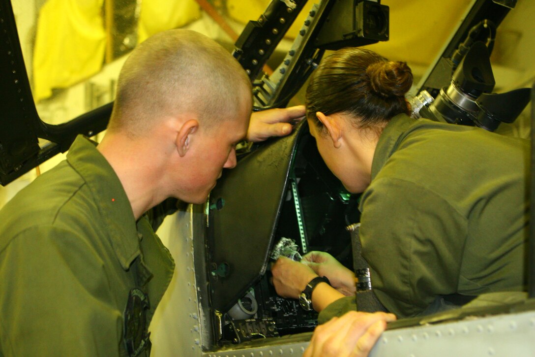 Corporals Evan Nuzum and Alma Munoz, both avionics technicians from Marine Medium Helicopter Squadron 265 Reinforced (HMM-265 REIN), 31st Marine Expeditionary Unit (MEU), repair a connector with the control display unit of a UH-1N Twin Huey helicopter in the hangar bay aboard the forward-deployed amphibious assault ship USS Essex (LHD-2), Jan. 26. The 31st MEU is currently conducting its Spring Patrol of the Asia-Pacific region and is scheduled to participate in exercise Cobra Gold 2010 (CG’ 10). The exercise is the latest in a continuing series of exercises designed to promote regional peace and security.
