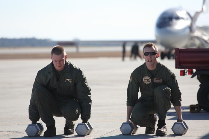 Lance Cpl. Blake Edwards, a rescue swimmer, and Petty Officer 2nd Class Ryan E. Honnoll, a search and rescue medical technician, both with Marine Transport Squadron 1, prepare to perform the second leg of their SAR fitness test outside the VMR-1 hangar.