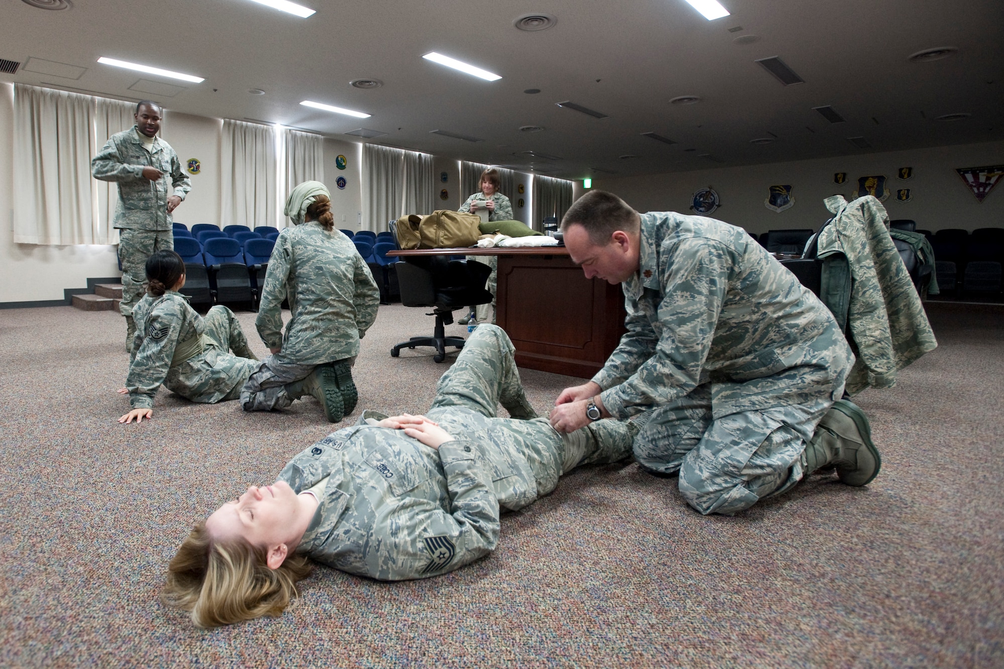 MISAWA AIR BASE, Japan -- A self-aid and buddy care class practices proper bandaging techniques under the instruction of Senior Airman Jamal Sutter, 35th Fighter Wing staff agencies self-aid and buddy care instructor, in the 35th FW conference room Jan. 26. The class gives Airmen the vital tools they need to save the lives of their fellow service members -- or themselves --  should the need arise. (U.S. Air Force photo/Staff Sgt. Samuel Morse)