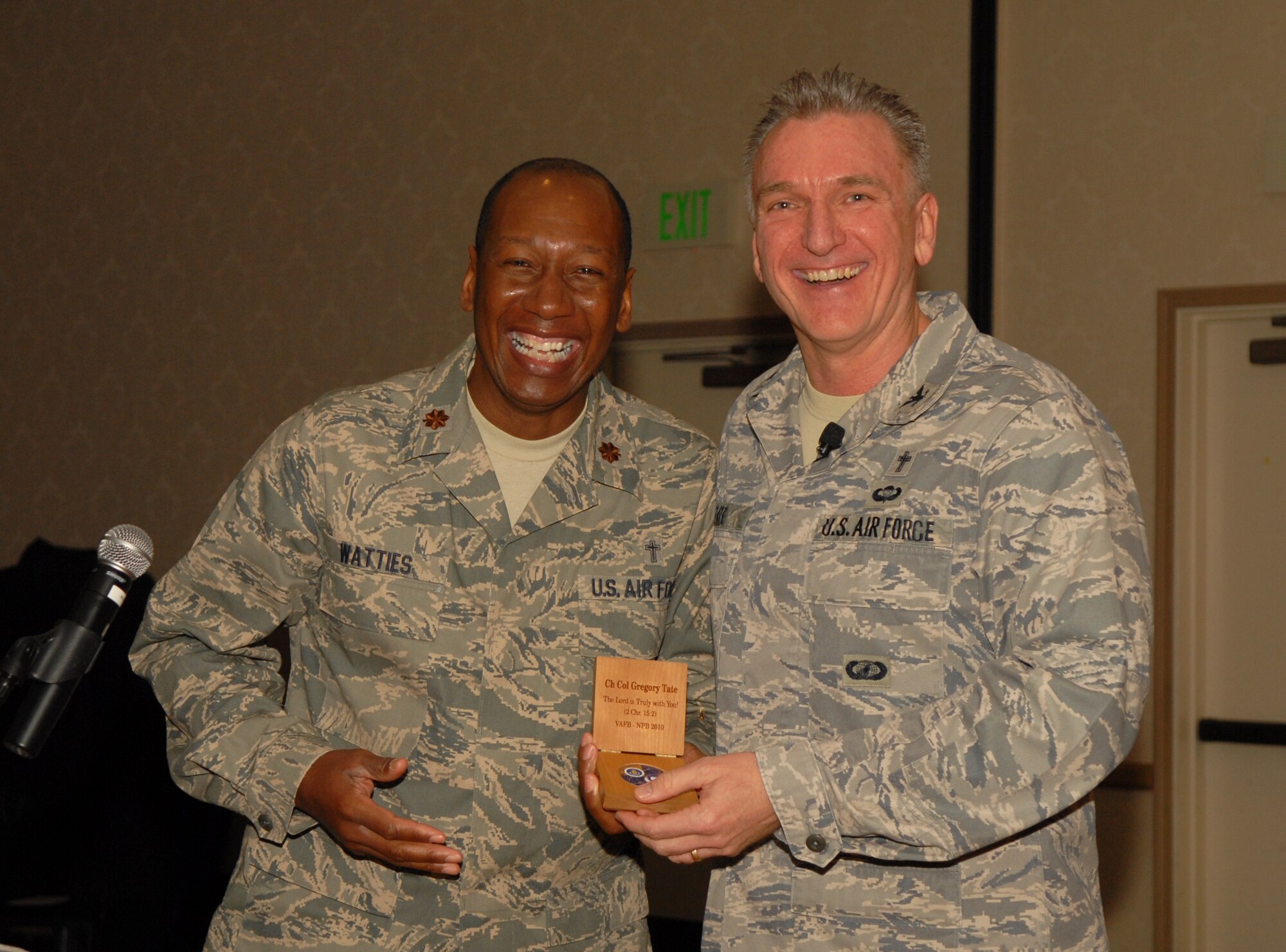 VANDENBERG AIR FORCE BASE, Calif. -- Chaplain (Maj.) Warren Watties, the 30th Space Wing chaplain presents Chaplain (Col.) Gregory Tate, the Air Force Space Command chaplain with a Vandenberg chaplain coin as a token of appreciation for being the guest speaker during the National Prayer Breakfast at the Pacific Coast Club here Tuesday, Jan. 25, 2010. The breakfast is held annually to unite multiple religions in prayer for the U.S.(U.S. Air Force photo/Airman 1st Class Kerelin Molina)