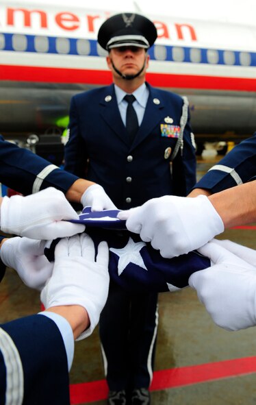 EL PASO, Texas -- Members of the Holloman Air Force Base, N.M., Steel Talons Honor Guard fold the U.S. flag during a dignified transfer, Jan. 22. A dignified transfer is conducted to honor those who have given their lives for the service of their country. (U.S. Air Force photo by Senior Airman Tiffany Trojca)    
