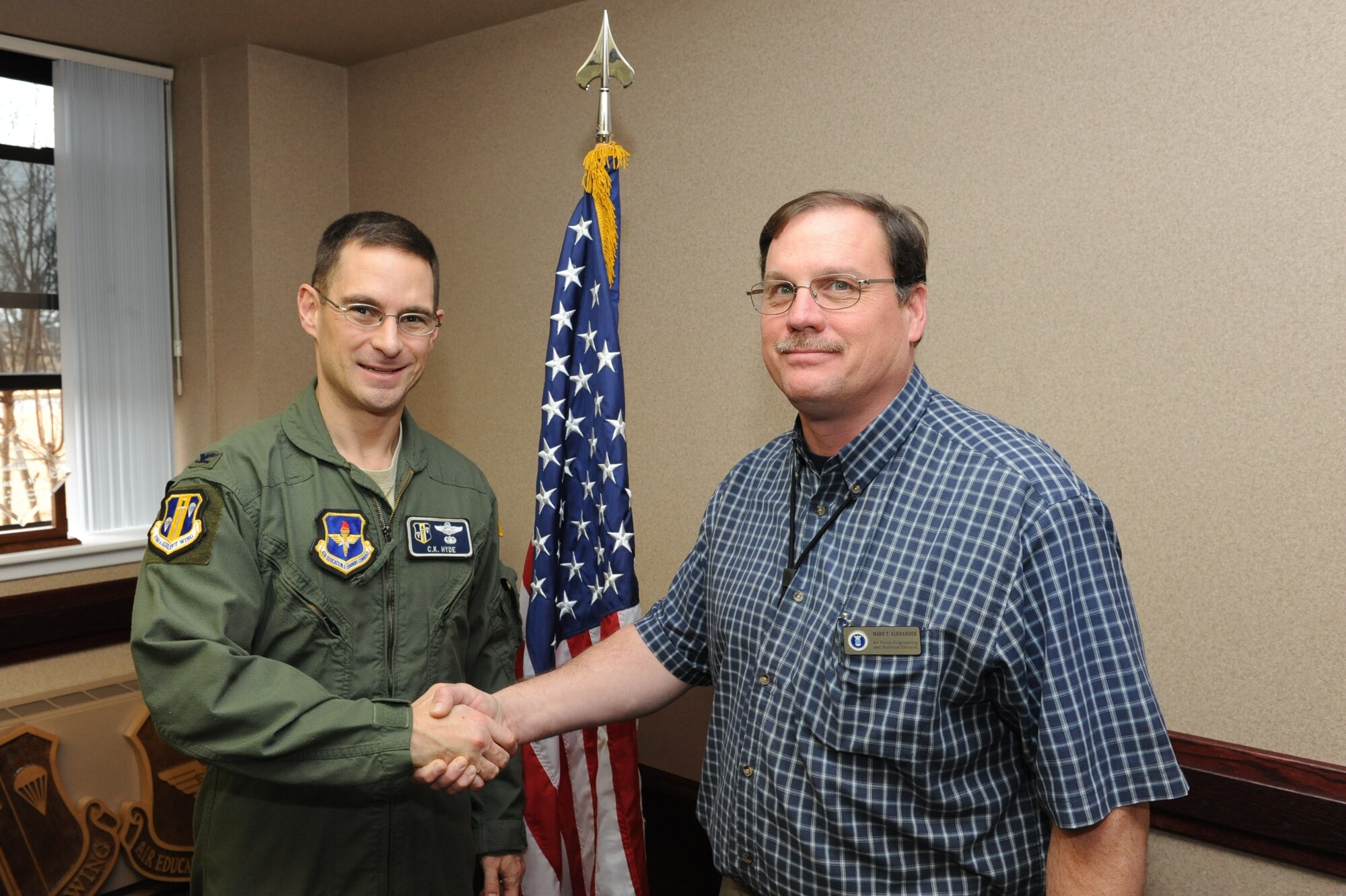 Col. C.K. Hyde, 314th Airlift Wing commander, presents Mark Alexander, 314th Maintenance Group lead Air Force engineering and technical services specialist, with a commander’s coin Jan. 13. Mr. Alexander was recently named the Air Education and Training Command lead AFET support specialist of the year in his respective category.