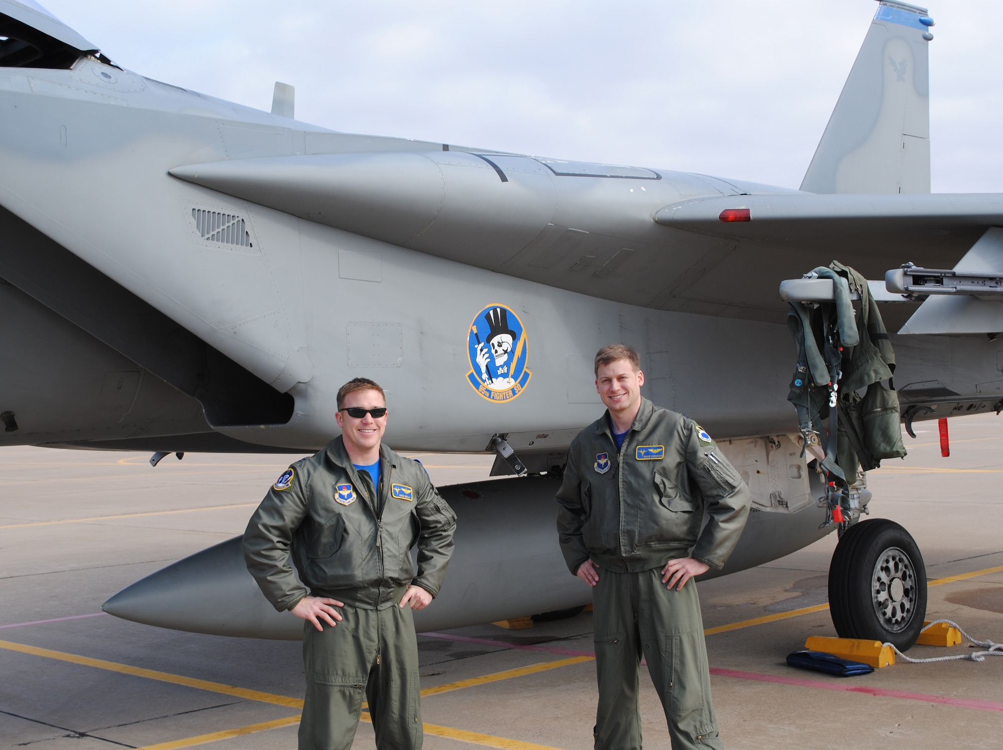 Captains David Siemion and Mike Reilly of the 95th Fighter Squadron stand in front of one of four F-15 Cs that diverted to Vance Air Force Base from Sheppard AFB, Texas, Jan. 15. Inclement weather interfered with the squadron’s plan to provide Euro-NATO student pilots with an F-15 C orientation brief. Sheppard AFB was one stop along a trip planned from Tyndall AFB, Fla., home of the 95th FS, and infamous squadron mascot “Mr. Bones,” to Hill AFB, Utah. The four F-15 Cs refueled at Vance AFB. 