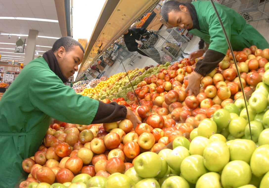 Pierce Hunt, a Defense Commissary Agency store associate, puts fresh apples on display for Joint Base Andrews patrons Jan. 15, 2010. The produce section is staffed by 13 workers, who manage a fluctuating inventory of fruit and vegetables on a daily basis. The Commissary received a shipment of approximately 20,963 pounds of food Jan. 15. (U.S. Air Force photo by Bobby Jones)