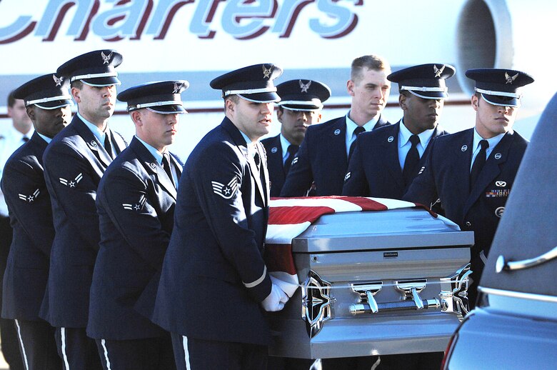 Base honor guard members perform the dignified transfer of Tech. Sgt. Adam Ginett Jan.25, 2010 AT Seymour Johnson Air Force Base, N.C. Sergeant Ginett, a fallen explosive ordnance disposal technician, wasassigned to the 31st Civil Engineer Squadron at Aviano Air Base, Italy. (U.S. Air Force photo/Senior Airman Ciara Wymbs)