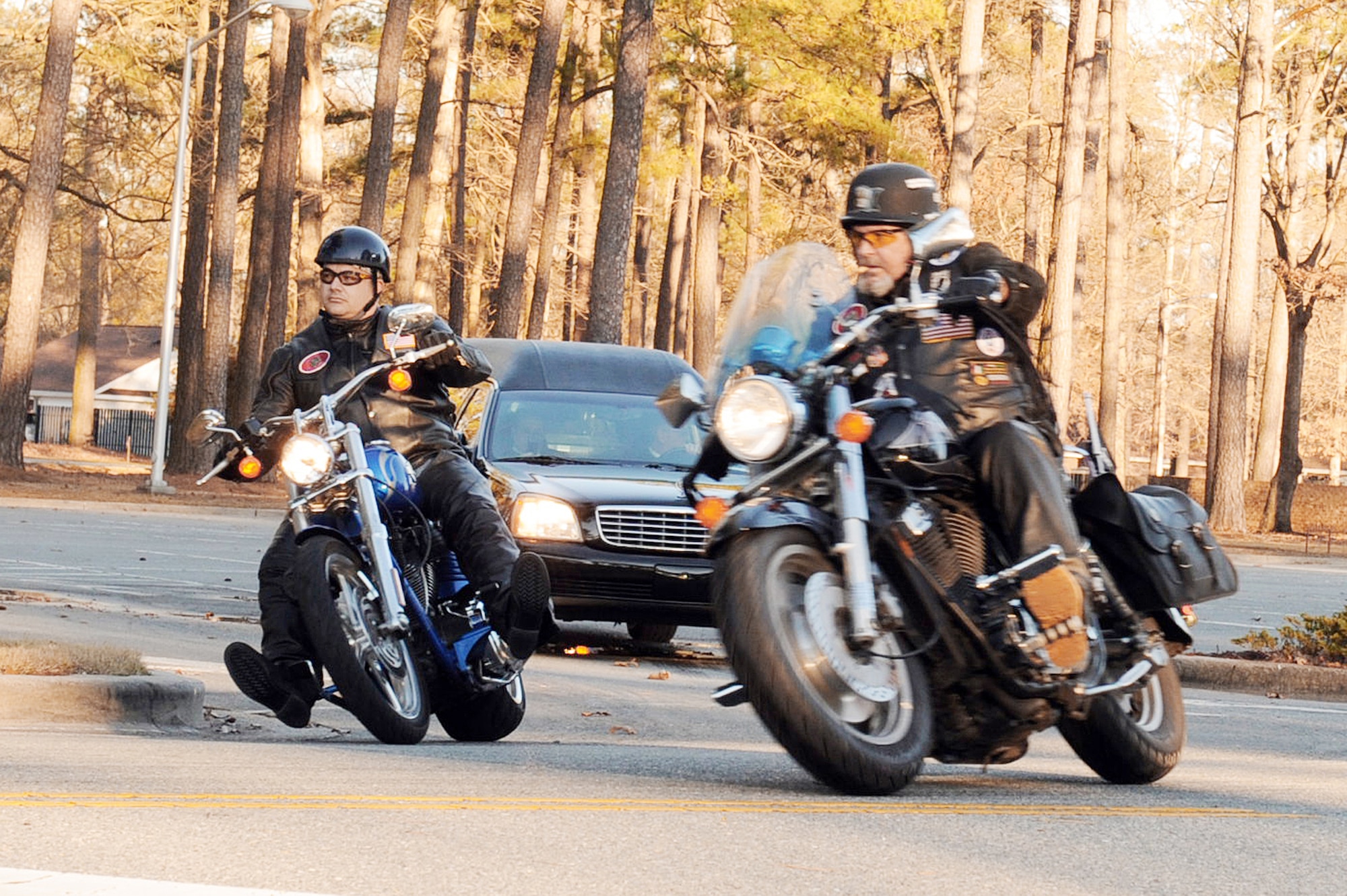 Members of the Patriot Guard Riders escort the remains Tech. Sgt. Adam Ginett, a fallen explosive ordnance disposal technician, Jan. 25, 2010, off Seymour Johnson Air Force Base, N.C., after a dignified transfer ceremony. (U.S. Air Force photo/Senior Airman Whitney Lambert)