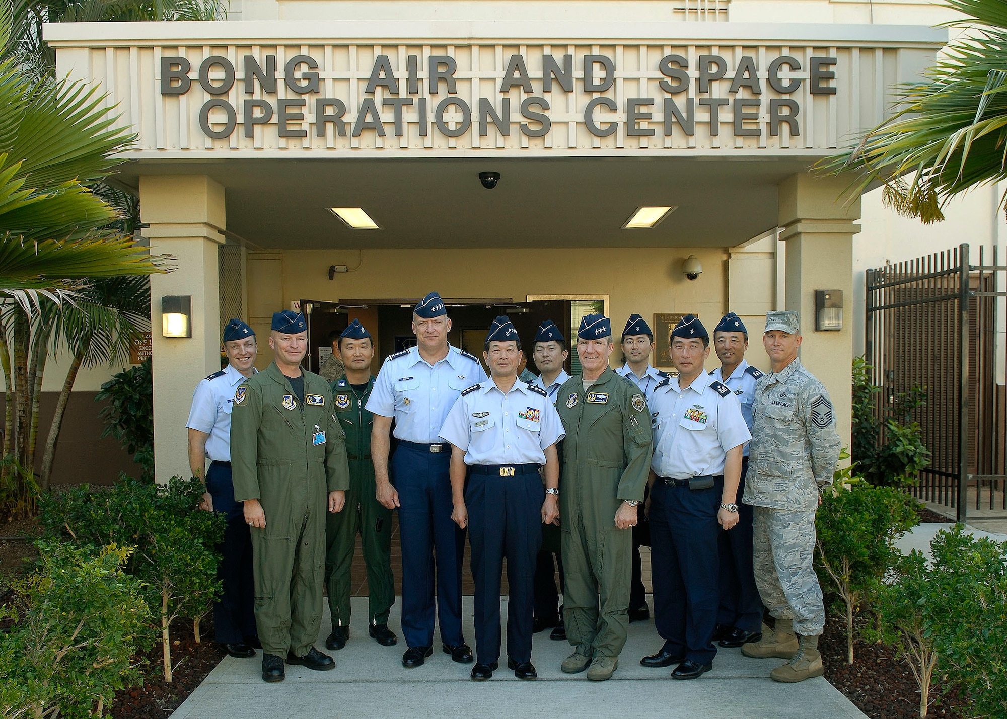 Gen. Gary North, Pacific Air Forces commander, General Kenichiro Hokazono, Japan Air Self-Defense Force chief of staff, and Lt. Gen. Hawk Carlisle, 13th Air Force commander, pose for a group photo in front of the 613th Air and Space Operations Center Jan. 25, 2010 at Hickam Air Force Base, Hawaii. General Hokazono and his delegation visited Hickam Jan. 23-25. The visit coincided with the commemoration of the 50th anniversary of the signing of the U.S.-Japan Treaty of Mutual Cooperation and Security.  The long-standing and strong relationship between the two partners continues to be key to regional stability in the Pacific. (U.S. Air Force photo/Tech. Sgt. Jerome S. Tayborn)