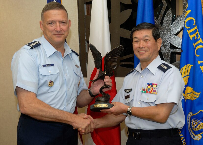 Gen. Gary North, Pacific Air Forces commander, exchanges a gift with General Kenichiro Hokazono, Japan Air Self-Defense Force chief of staff, Jan. 25, 2010 at Hickam Air Force Base, Hawaii. General Hokazono and his delegation visited Hickam Jan. 23-25. The visit coincided with the commemoration of the 50th anniversary of the signing of the U.S.-Japan Treaty of Mutual Cooperation and Security. The long-standing and strong relationship between the two partners continues to be key to regional stability in the Pacific. (U.S. Air Force photo/Tech. Sgt. Jerome S. Tayborn)