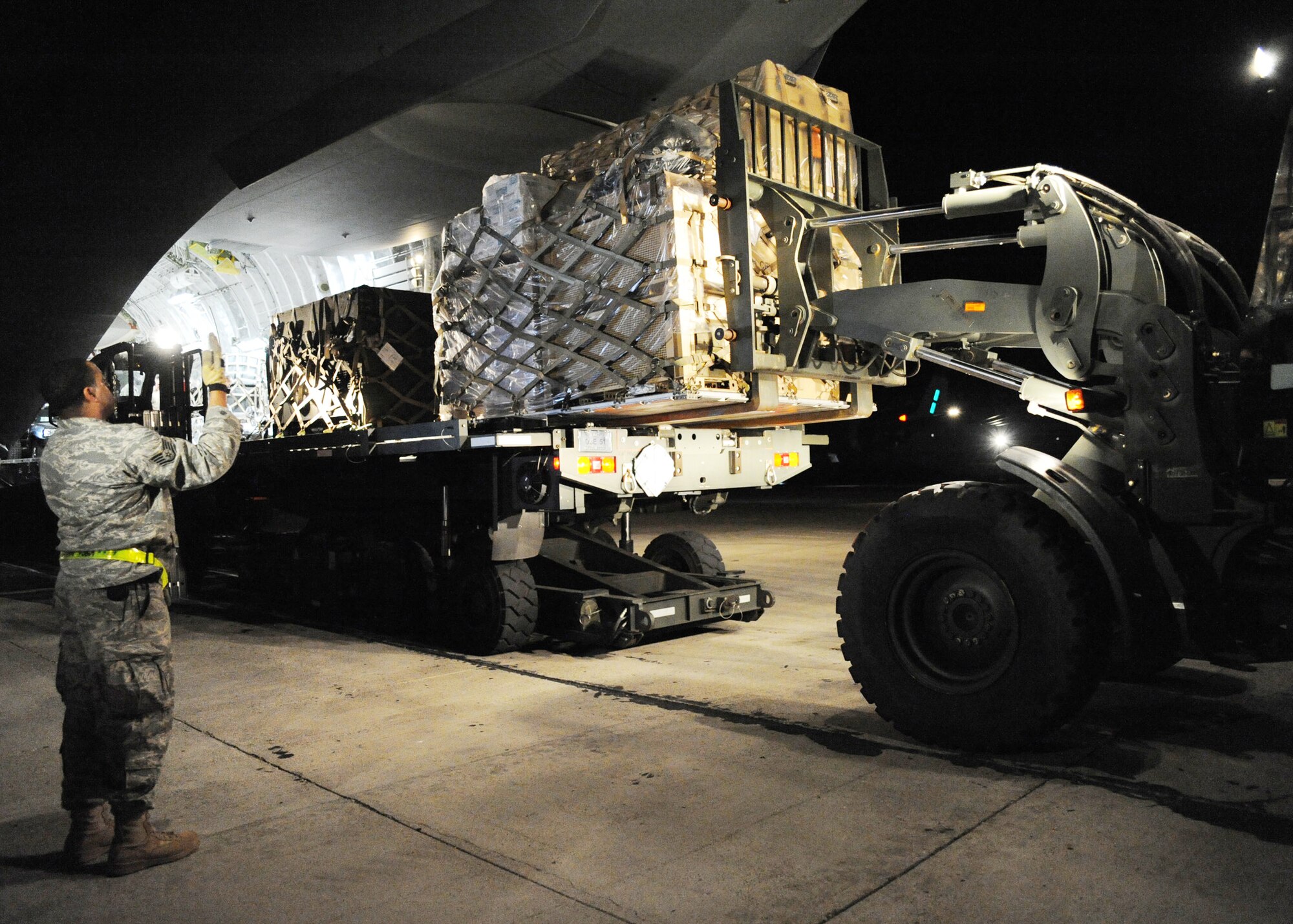 Equipment is unloaded from a C-17 Globemaster III in Port-au-Prince, Haiti, Jan. 15, 2010. The supplies are a continuous flow from Air Mobility Command to respond to the humanitarian effort in Haiti. (U.S.Air Force photo/Senior Airman Katie Gieratz)