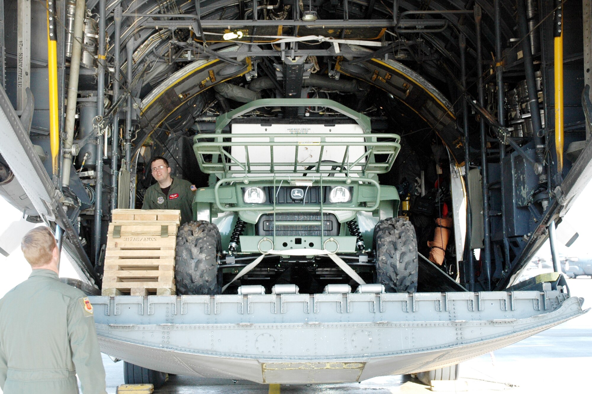 Staff Sgt. Henry Morgan discusses the load aboard a C-130 Hercules with a fellow loadmaster Jan. 17, 2010 at Pope Air Force Base, N.C. The C-130 crew of six departed Dyess AFB, Texas to support relief efforts following the 7.0-magnitude earthquake in Haiti Jan. 12, 2010. Sergeant Morgan is assigned to the 317th Airlift Group. (U.S. Air Force photo)
