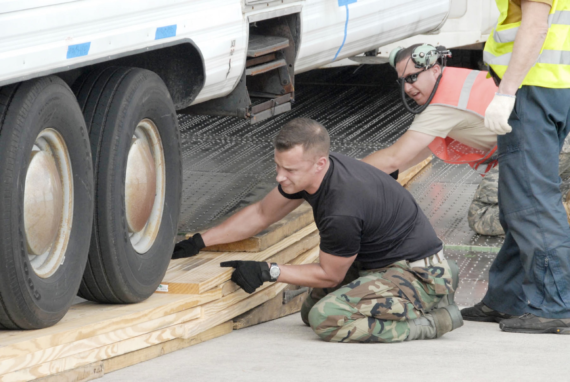 A Federal Aviation Administration mobile air traffic control tower is loaded onto a Russian-owned Antonov An-124 aircraft bound for the Port-au-Prince Airport in Haiti Jan. 21, 2010. The tower will serve as the main tower the airport. Tech Sgt. Jake Teufel and Staff Sgt. Ryan Snyder assist members of the Russian crew with approach shoring. Sergeants Teufel and Snyder are assigned to the 914th Maintenance Squadron. (U.S. Air Force photo/Master Sgt. Chance Babin)
