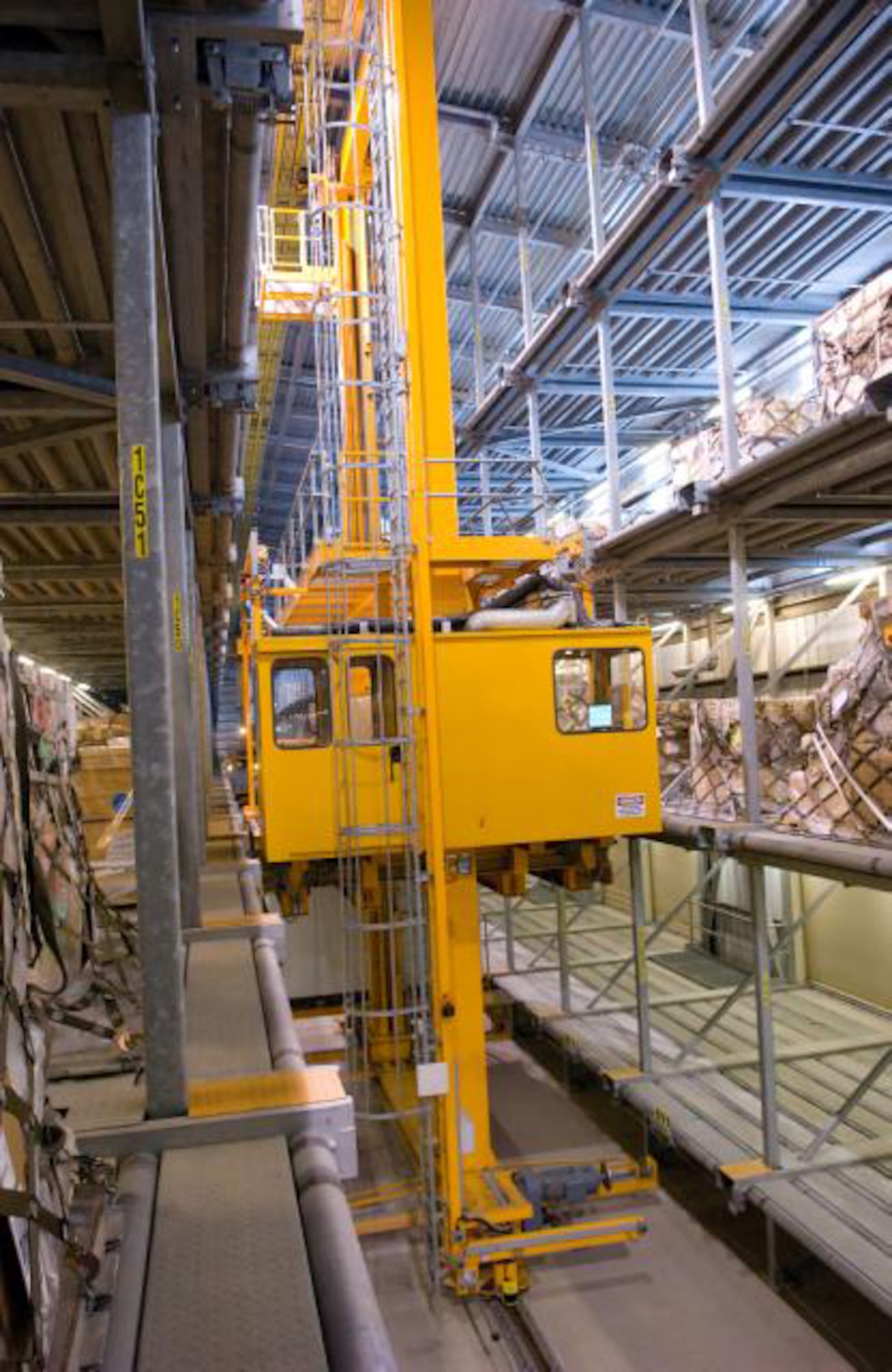 Inside the holding area of the 436th Aerial Port Squadron the Elevating Transfer Vehicle picks up and moves pallets of cargo to be placed on a jet. This holding area has the capacity to hold 590 pallets at one time. (U.S. Air Force photo/ Jason Minto)