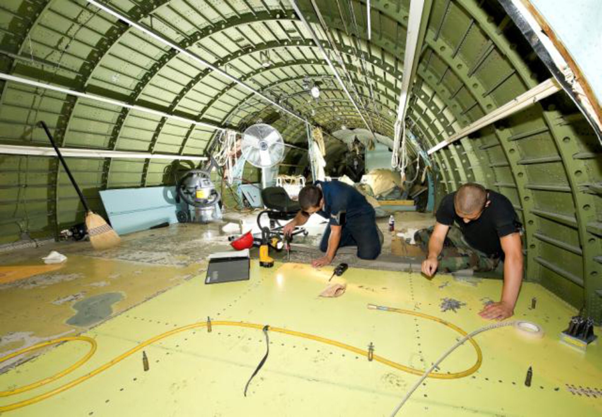 436th MXG members work to install a new floor panel, as part of the Maintenance Steering Group Three Major inspection. The inspection is a thorough structural inspection, including 3,400 new technical orders never performed at Dover before August of 2009. Many of the new inspections have not been done since the plane was originally built. (U.S. Air Force photo / Jason Minto)