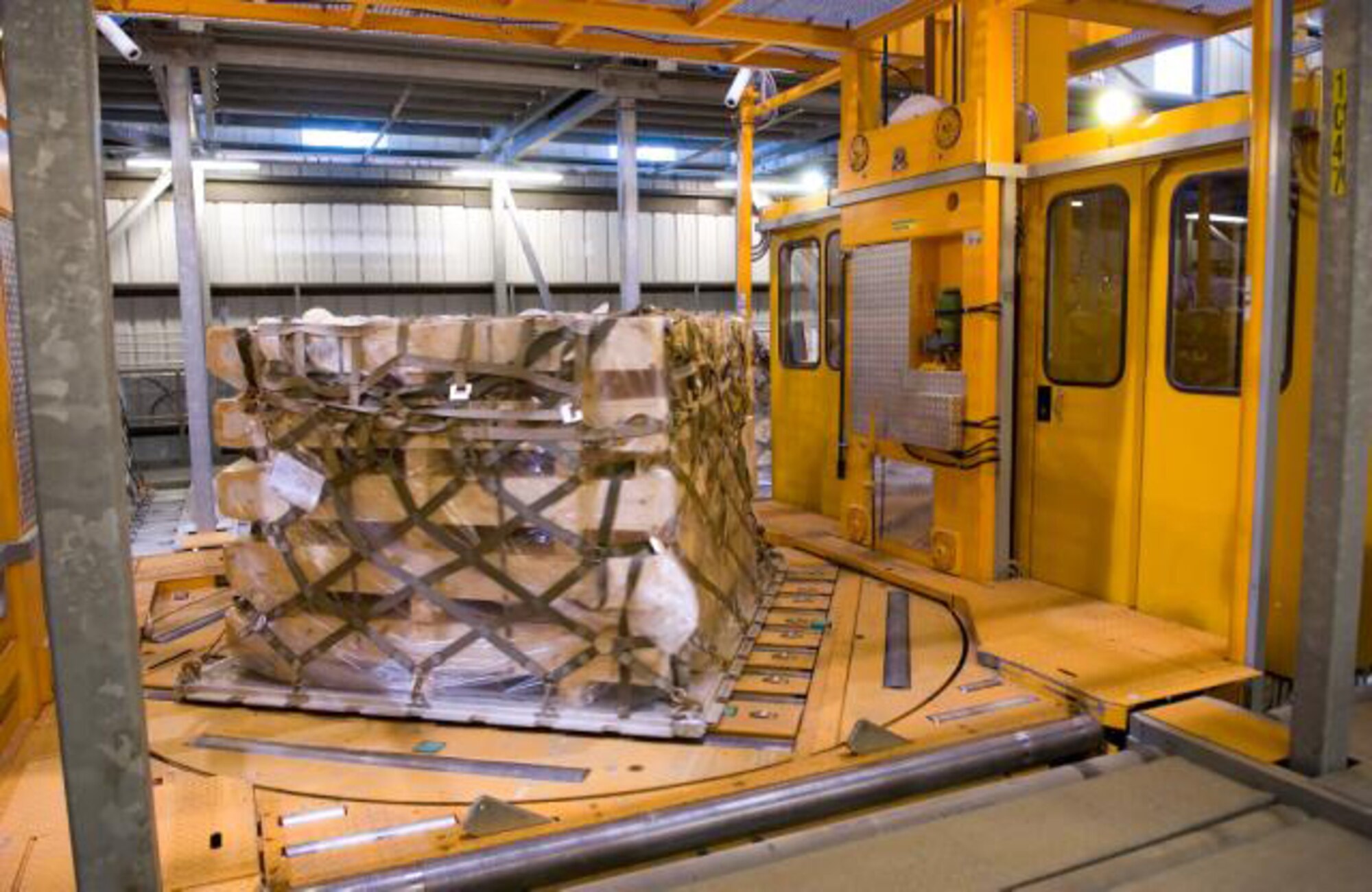 In the holding area of the 436th Aerial Port Squadron, the Elevating Transfer Vehicle has picked up this pallet and moved it to an outside loading dock to be placed on a K-loader. This holding area has the capacity to hold 590 pallets at one time. (U.S. Air Force photo/ Jason Minto)