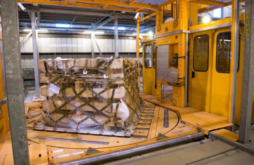 In the holding area of the 436th Aerial Port Squadron, the Elevating Transfer Vehicle has picked up this pallet and moved it to an outside loading dock to be placed on a K-loader. This holding area has the capacity to hold 590 pallets at one time. (U.S. Air Force photo/ Jason Minto)