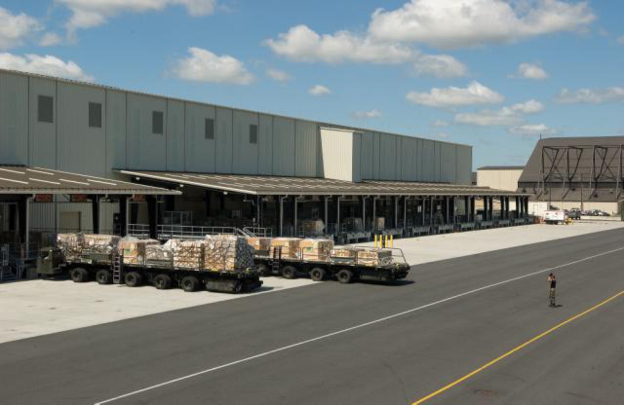 The outside of the holding area drops off right to the flightline to expedite the transport of cargo. Cargo is taken out of the holding area on K-loaders and loaded directly on a cargo plane. This holding area preserves flightline space while keeping the cargo area in close proximity to the aircraft. (U.S. Air Force photo/ Jason Minto)