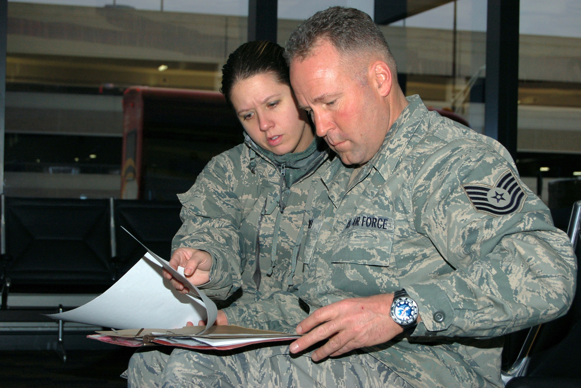 1st Lt. Cheryl L. Mead, the installation deployment officer, 103rd Logistics Readiness Squadron, reviews a deployment checklist with Tech. Sgt. Gregory Jones, readiness trainer with the 103rd Force Support Squadron. According to Mead, the turn around time from when Jones was notified and was then on a plane to leave for Haiti as part of a relief mission was just 17 hours. (U.S. Air Force photo by Tech. Sgt. Josh Mead)