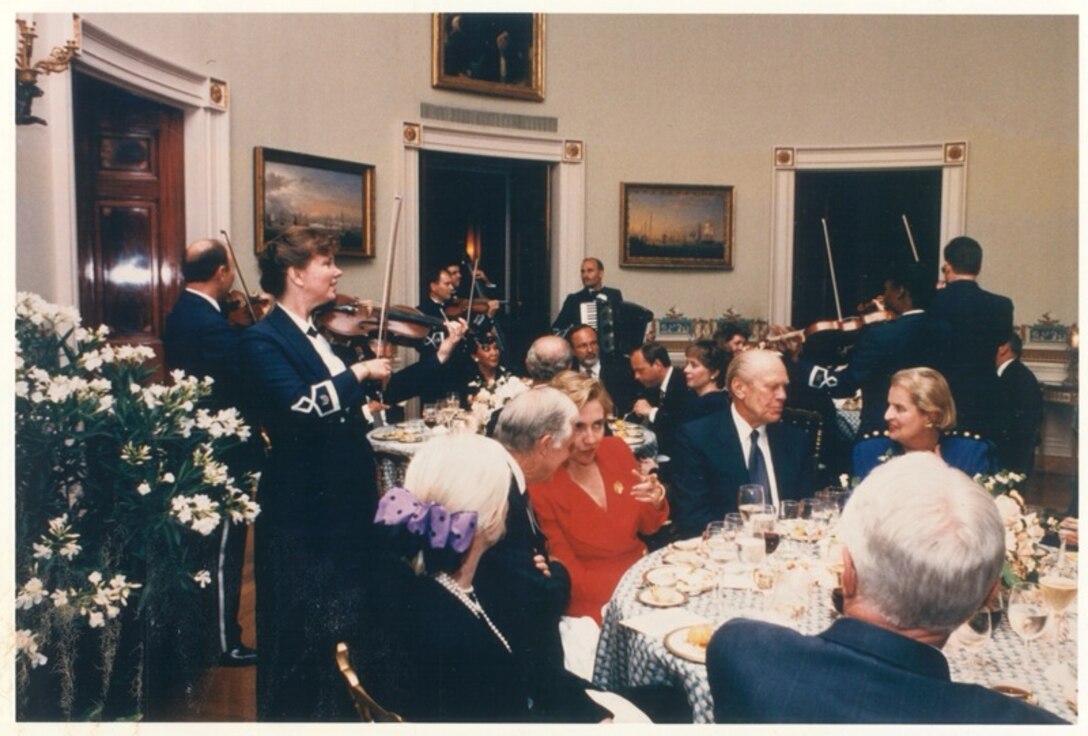 Members of the Strolling Strings entertain White House dinner guests.   Guests included, Former President Jimmy Carter, First Lady Hillary Clinton, Former President Gerald Ford, and Secretary of State Madeleine Albright.  If you have any additional information about this event, please email our Band Historian <a href="mailto:usafbandhistorian@afncr.af.mil">Technical Sgt. Tracey MacDonald</a>. Thank you and we look forward to hearing from you!  This is Photo 25. (Unknown Photo)